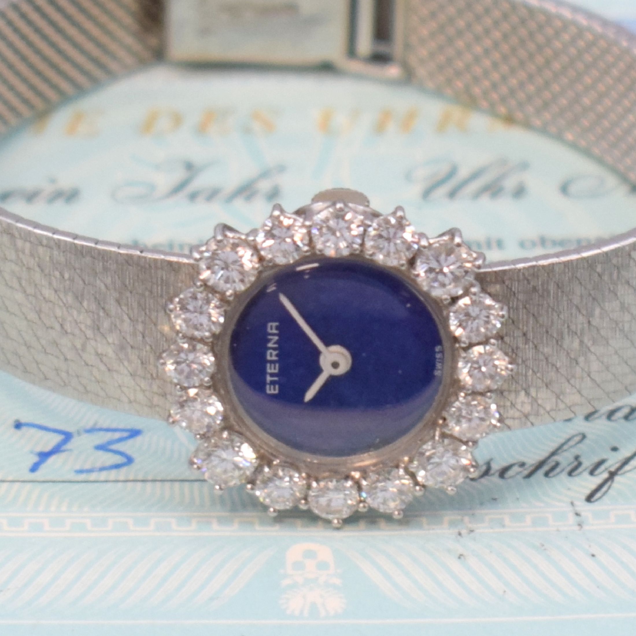 Detail a: ETERNA Damenarmbanduhr in WG 750/000 mit Diamanten, Schweiz verk. lt. beil. Garantie 03/1973, Handaufzug, Geh. an Goldband 750/000, Boden aufgedr., ...