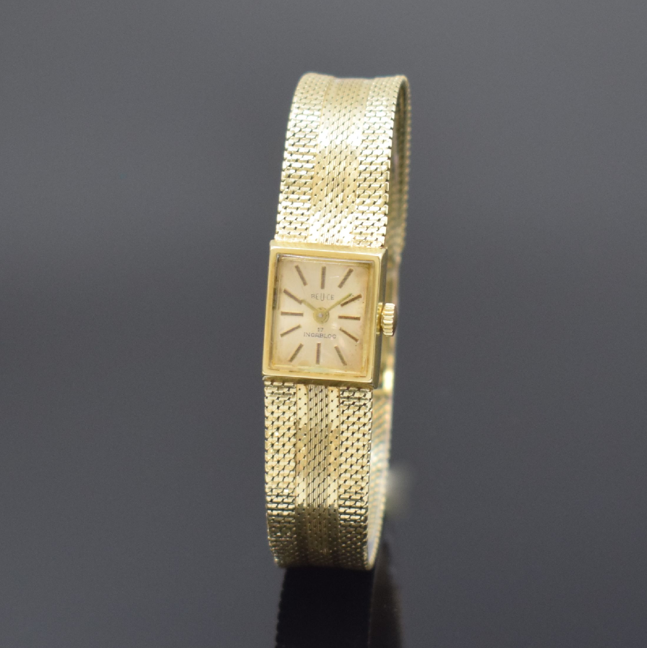 BEUCE / NIVADA Armbanduhr in GG 585/000, Schweiz um 1975, Handaufzug, Boden aufgedr., silb. Zifferbl. m. gold. Std.-Ind. altersbed. pat., gold. ...