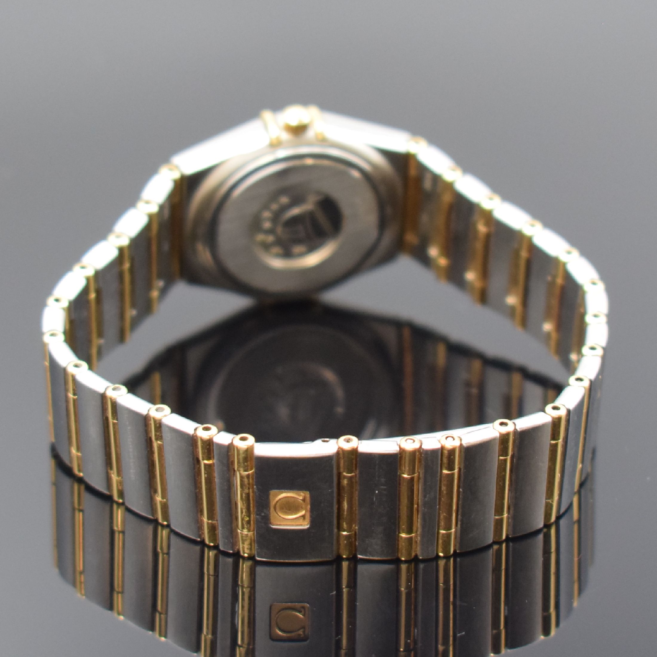 Detail b: OMEGA Constellation Damenarmbanduhr in Stahl/Gold, Schweiz um 1995, quarz, Boden aufgedr., Gliederband m. Faltschl., Goldlünette m. röm. Zahlen, ...