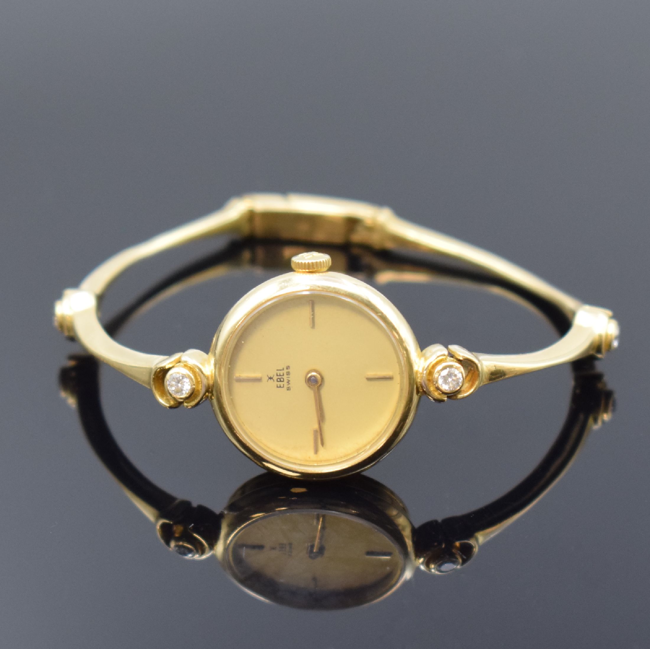 EBEL Damenarmbanduhr in GG 750/000 mit Diamanten, Schweiz um 1980, quarz, GG-Band m. 4 Diamanten, Boden aufgedr., champagnerfarb. Zifferbl. m. gold. ...