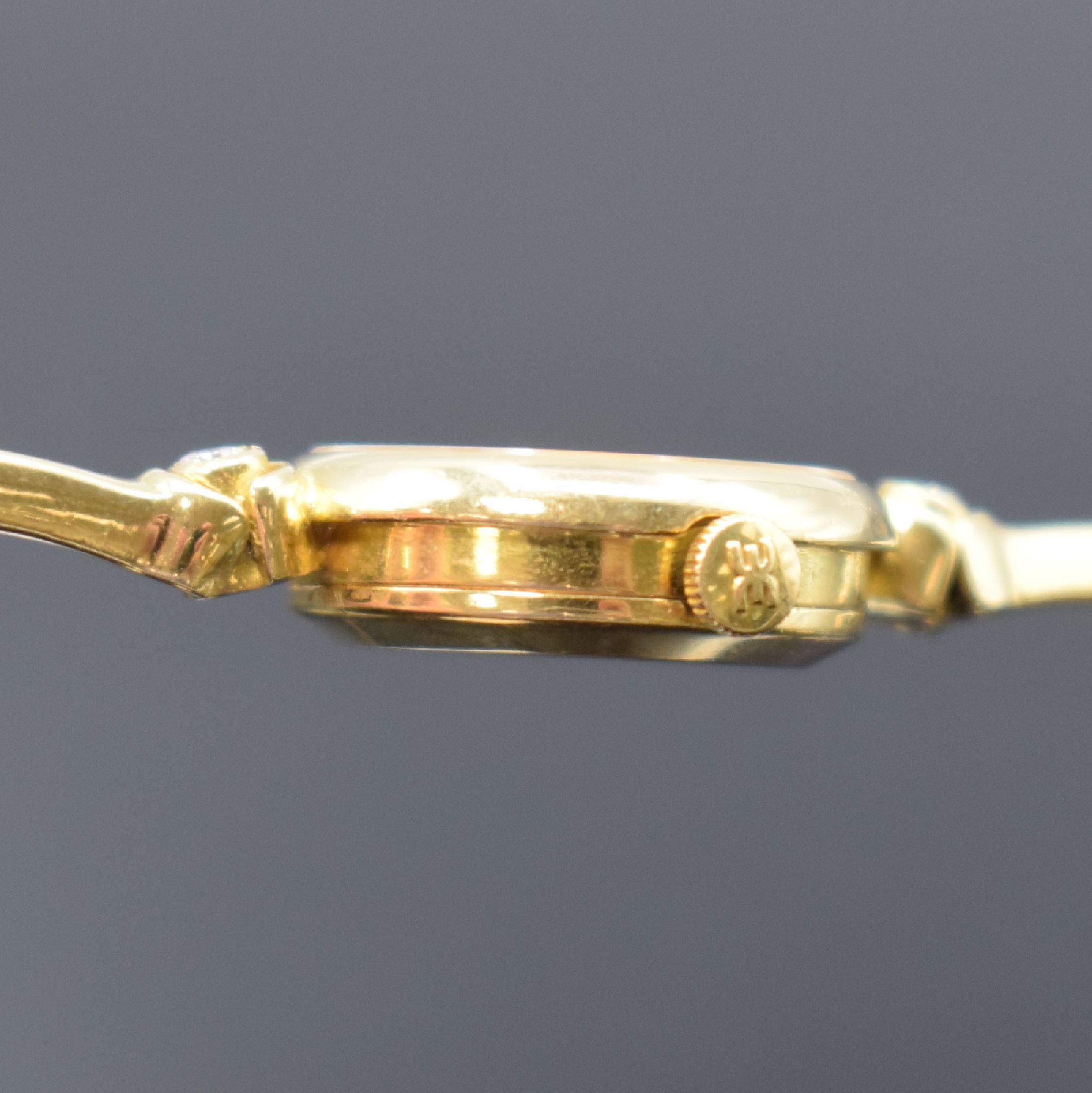 Detail e: EBEL Damenarmbanduhr in GG 750/000 mit Diamanten, Schweiz um 1980, quarz, GG-Band m. 4 Diamanten, Boden aufgedr., champagnerfarb. Zifferbl. m. gold. ...