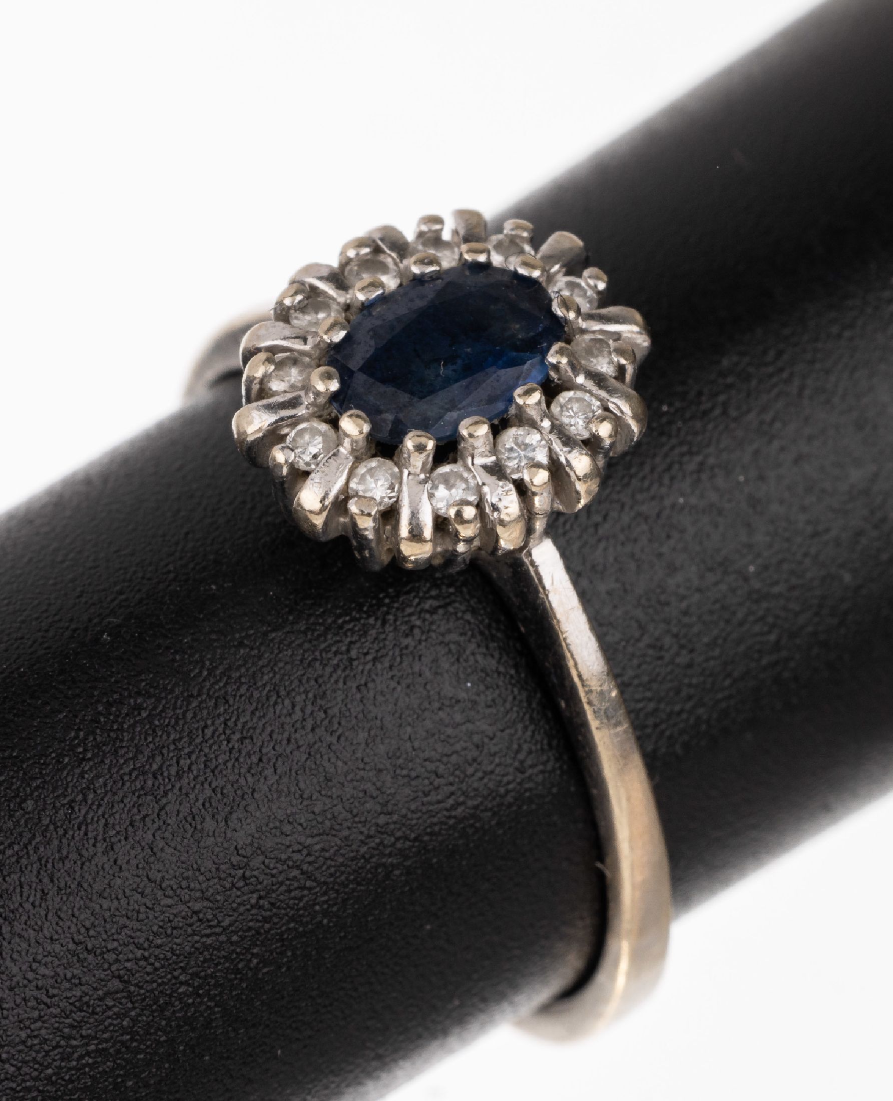 14 kt Gold Saphir-Brillant-Ring, WG 585/000, ovalfacett. Saphir ca. 0.30 ct, 12 Brillanten zus. ca. 0.12 ct Weiß/si-p, RW 55, total ca. 2.6 g