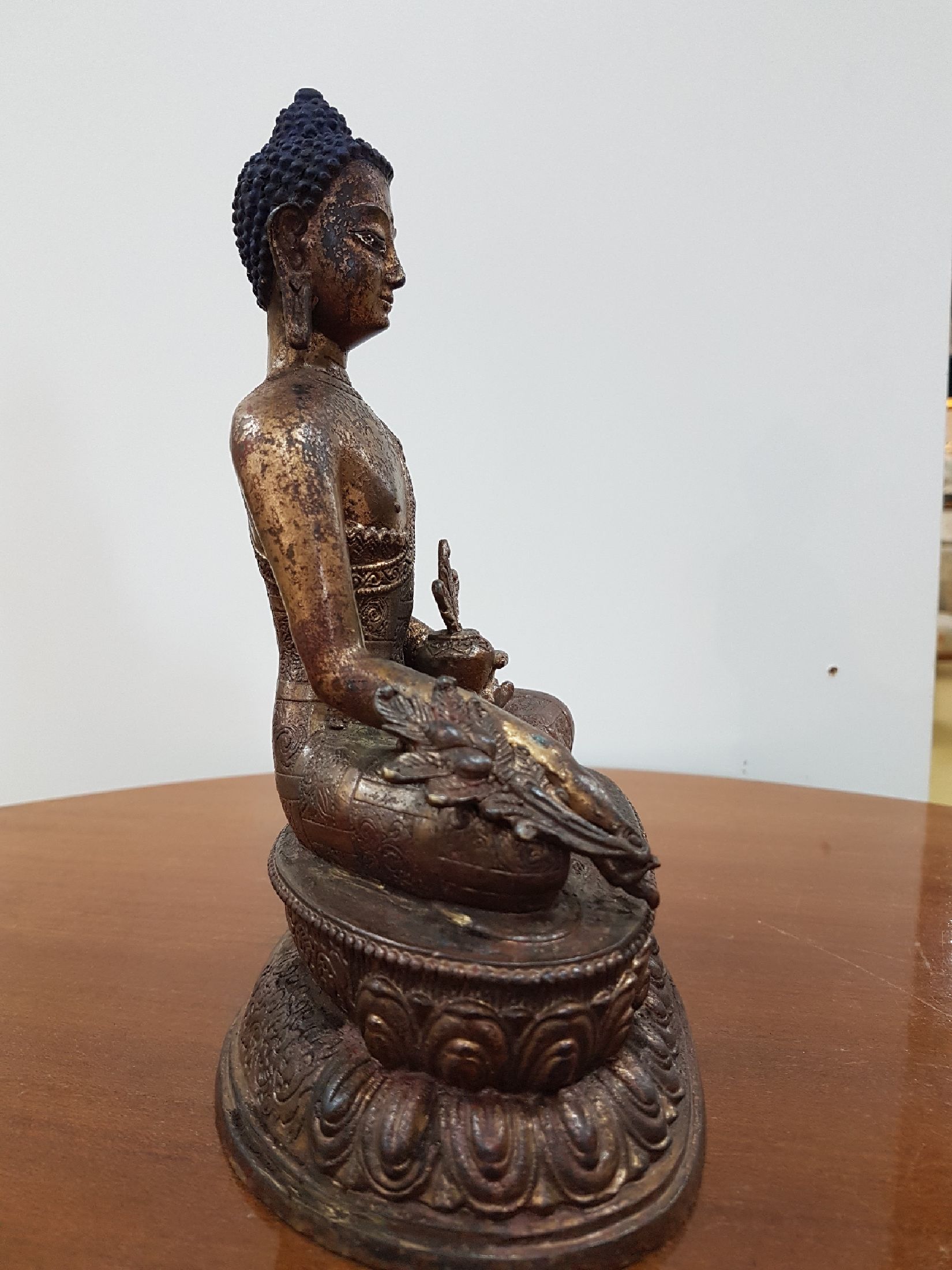 Detail e: Medizin-Buddha, Tibet, um 1900, Bronze, Reste von Vergoldung, verziertes Gewand, ca. 22 x 16 x 11 cm