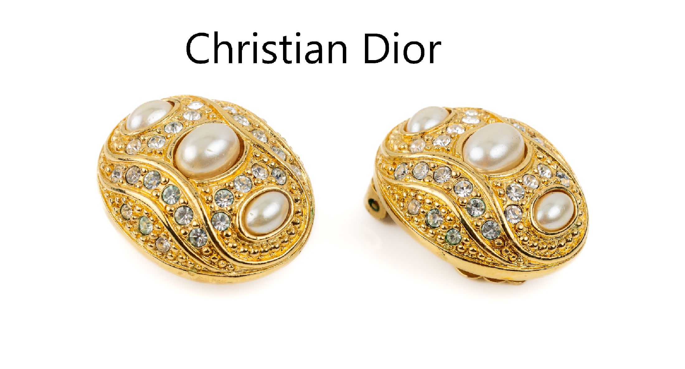 Paar CHRISTIAN DIOR Ohrclips, Metall verg.,oval, farbloser Strassbesatz und ovale Kunstperlen, sign.