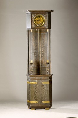 Image 26651727 - Grandfather clock, species Nouveau, Darmstadt area, around 1900, solid oak body stained dark, attractive brass appliqués, fine floral carvings, swing area of the pendulum is open, decorated brass dial with raised number circle, hands typical of the time, massive Brass plate movement according to: Lorenz Furtwängler & Sons, Graham gang with pallets, drive via chains and weights, running approx. 1 week, half hour Strike on a large gong, H. approx. 225cm, condition of movement/housing 2-3