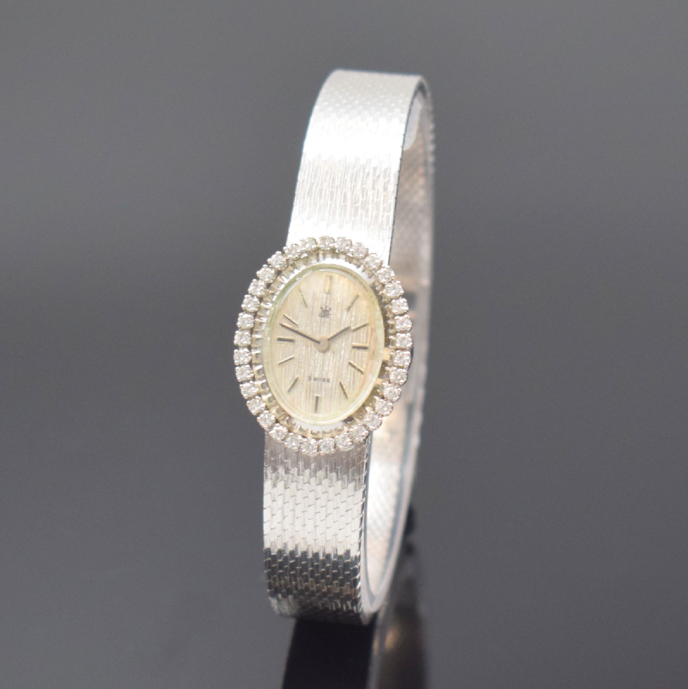 GHC Damenarmbanduhr in WG 585/000, Schweiz um 1970, Handaufzug, 2-teil. Geh., Boden aufgedr., Milanaiseband, Lünette m. Diamanten bes., silb. ...