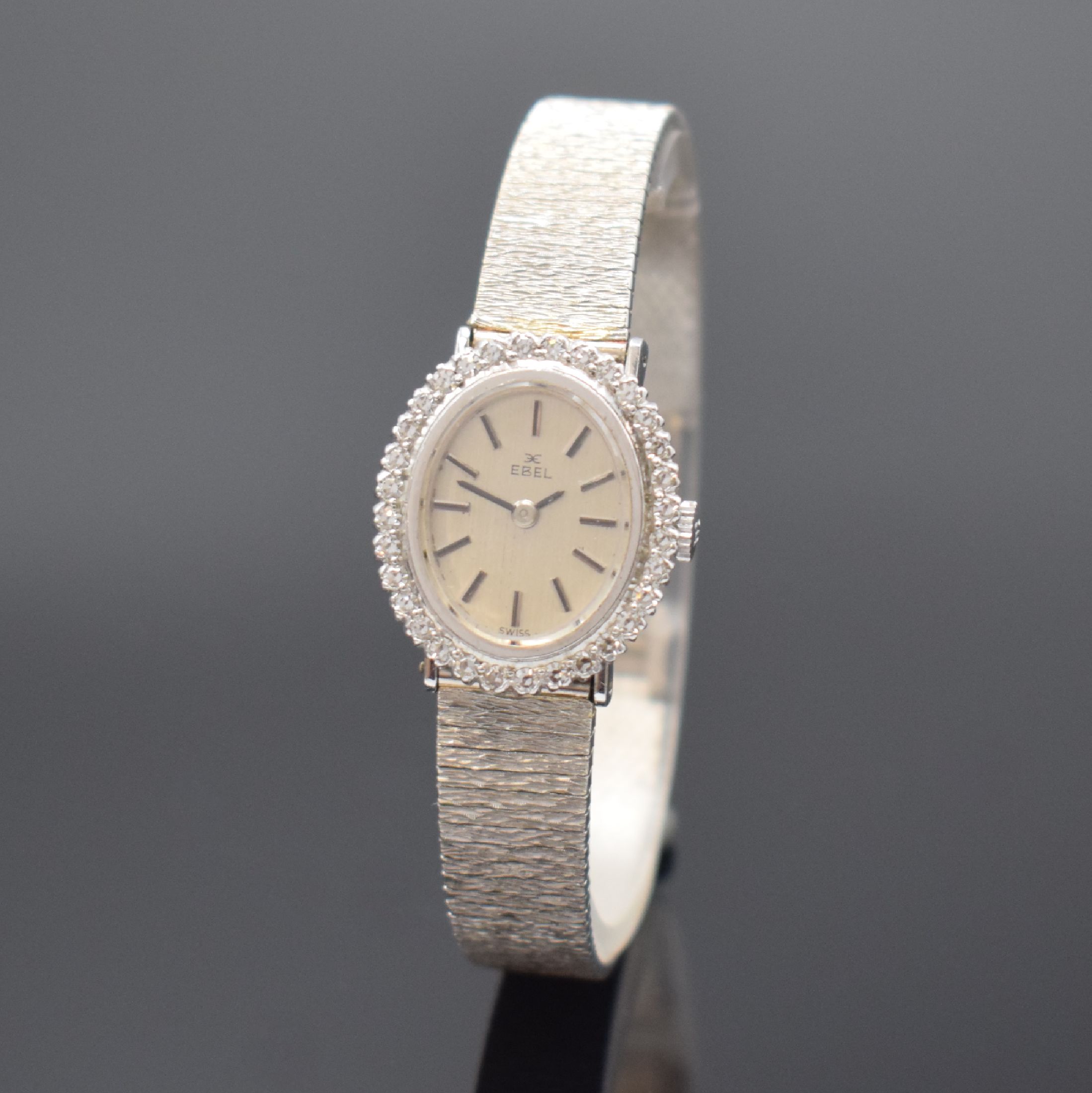 EBEL Damenarmbanduhr in WG 750/000 mit Diamanten, Schweiz um 1965, Handaufzug, Boden aufgedr., Lünette aufw. m. Diamanten bes., silb. Zifferbl. m. ...