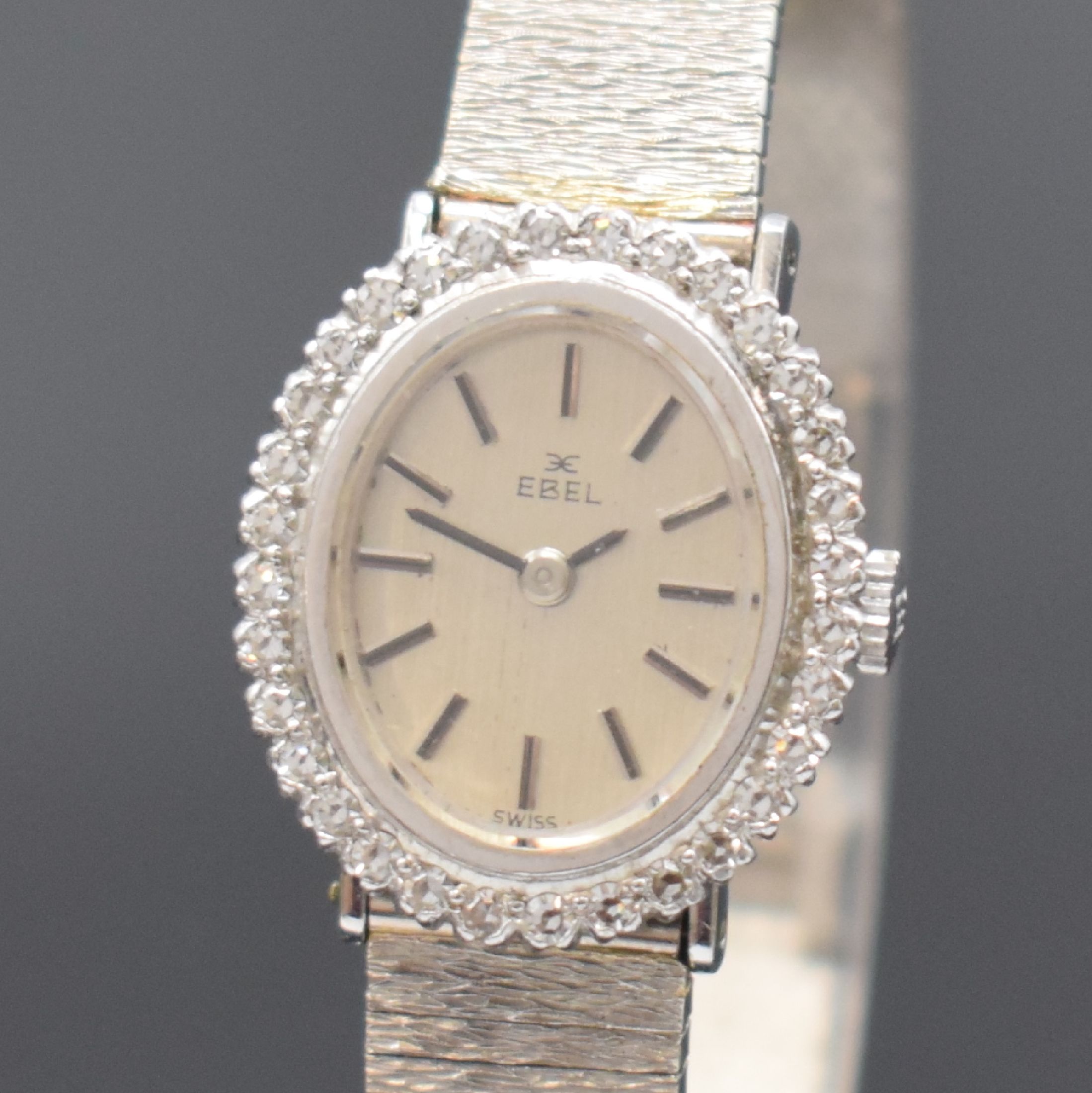 Detail a: EBEL Damenarmbanduhr in WG 750/000 mit Diamanten, Schweiz um 1965, Handaufzug, Boden aufgedr., Lünette aufw. m. Diamanten bes., silb. Zifferbl. m. ...