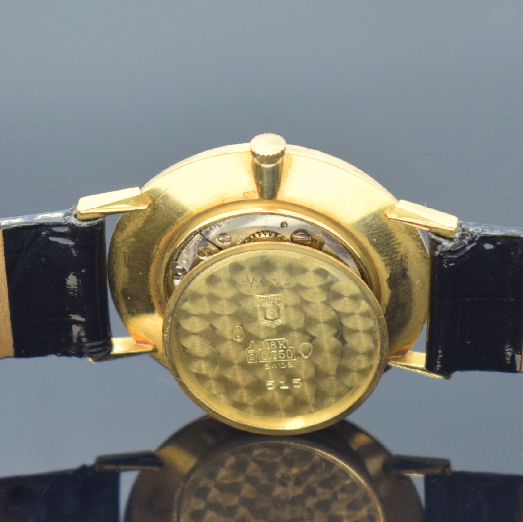 Detail e: UNIVERSAL GENEVE Herrenarmbanduhr in GG 750/000, Schweiz um 1975, Handaufzug, Boden aufgedr., weißes Zifferbl. fl./besch., arab. Zahlen, gebl. ...