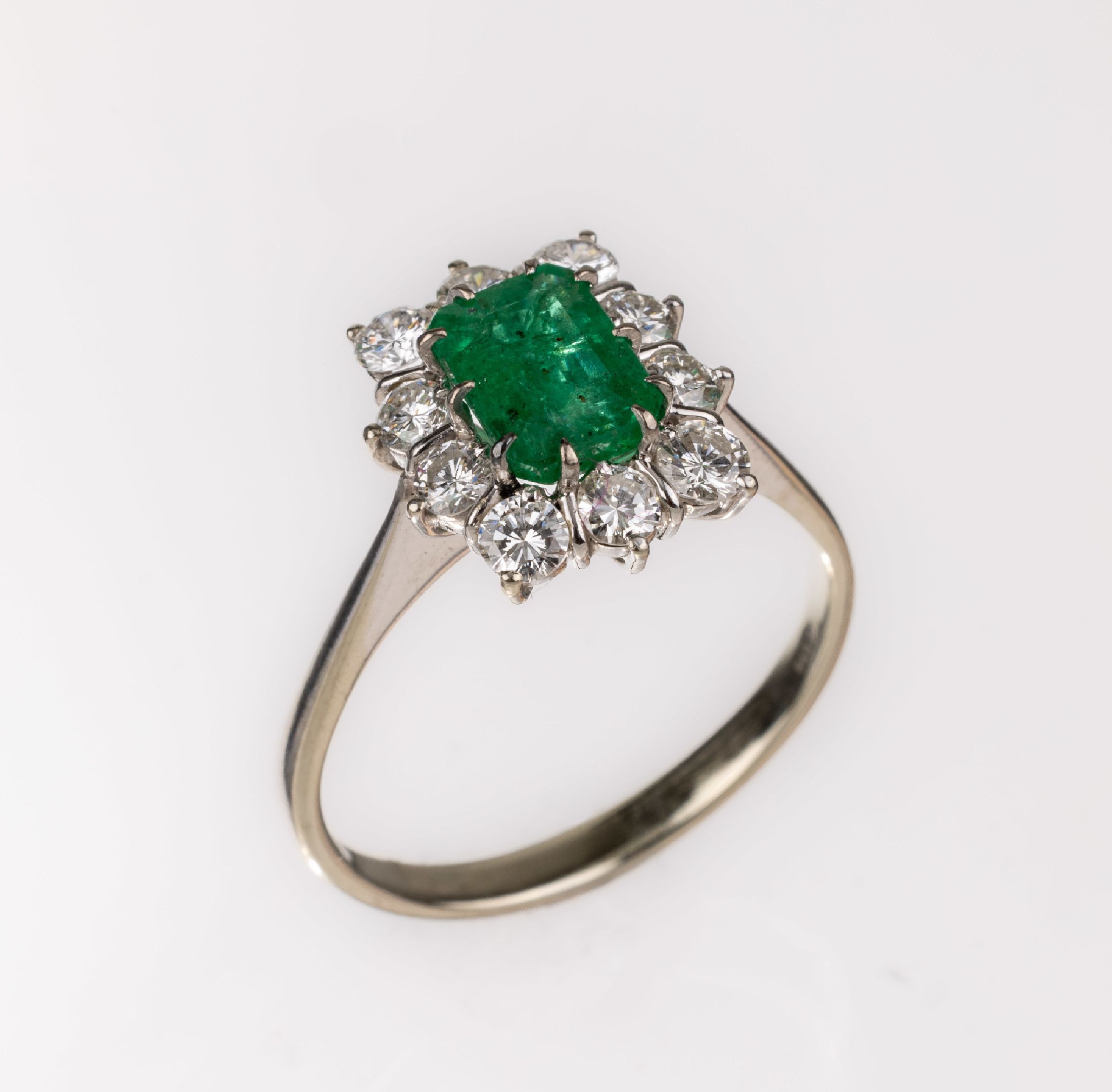 18 kt Gold Smaragd-Brillant-Ring, WG 750/000, mittig Smaragd im Treppenschliff ca. 0.70 ct, 10 Brillanten zus. ca. 1.0 ct Weiß/vs-si, RW 57, ca. ...