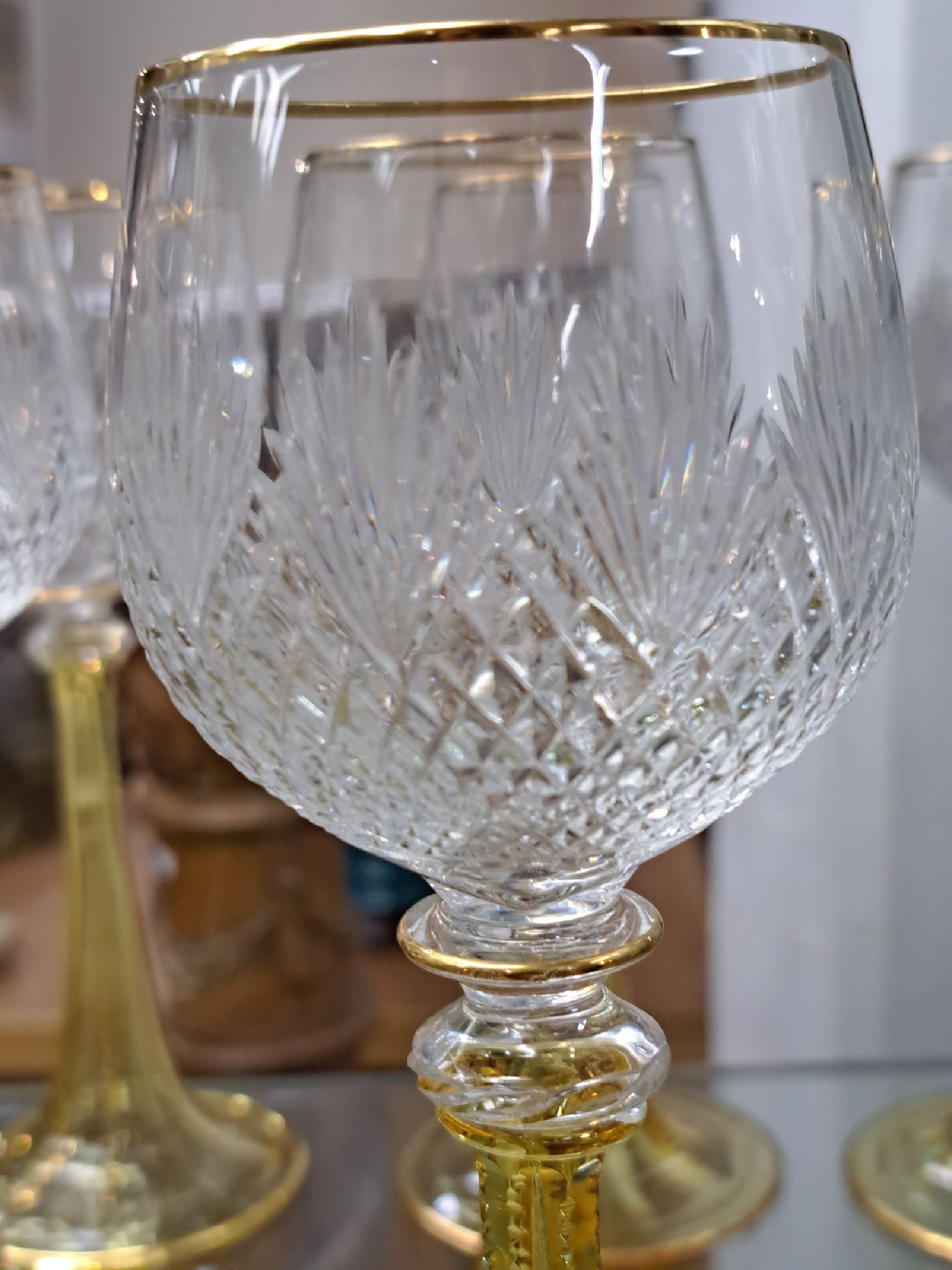 Detail b: 12 Weingläser um 1900, gelber trompetenförmiger Fuß mit acht geschliffenen Kanten, farblose Kuppa mit geschliffenem Fächerdekor, Goldränder, ...