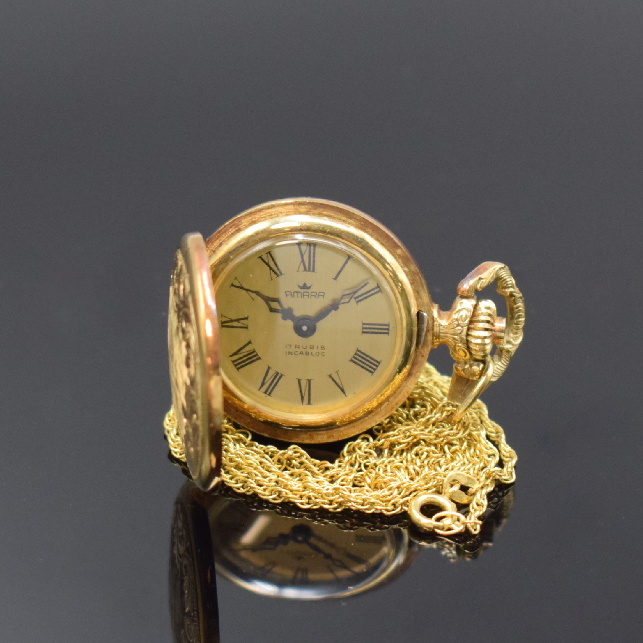 AMARA Damentaschenuhr in GG 585/000 mit Goldkette, Schweiz um 1975, Handaufzug, gold. Zifferbl. m. röm. Zahlen, schwarze Zeiger, Kette in GG ...