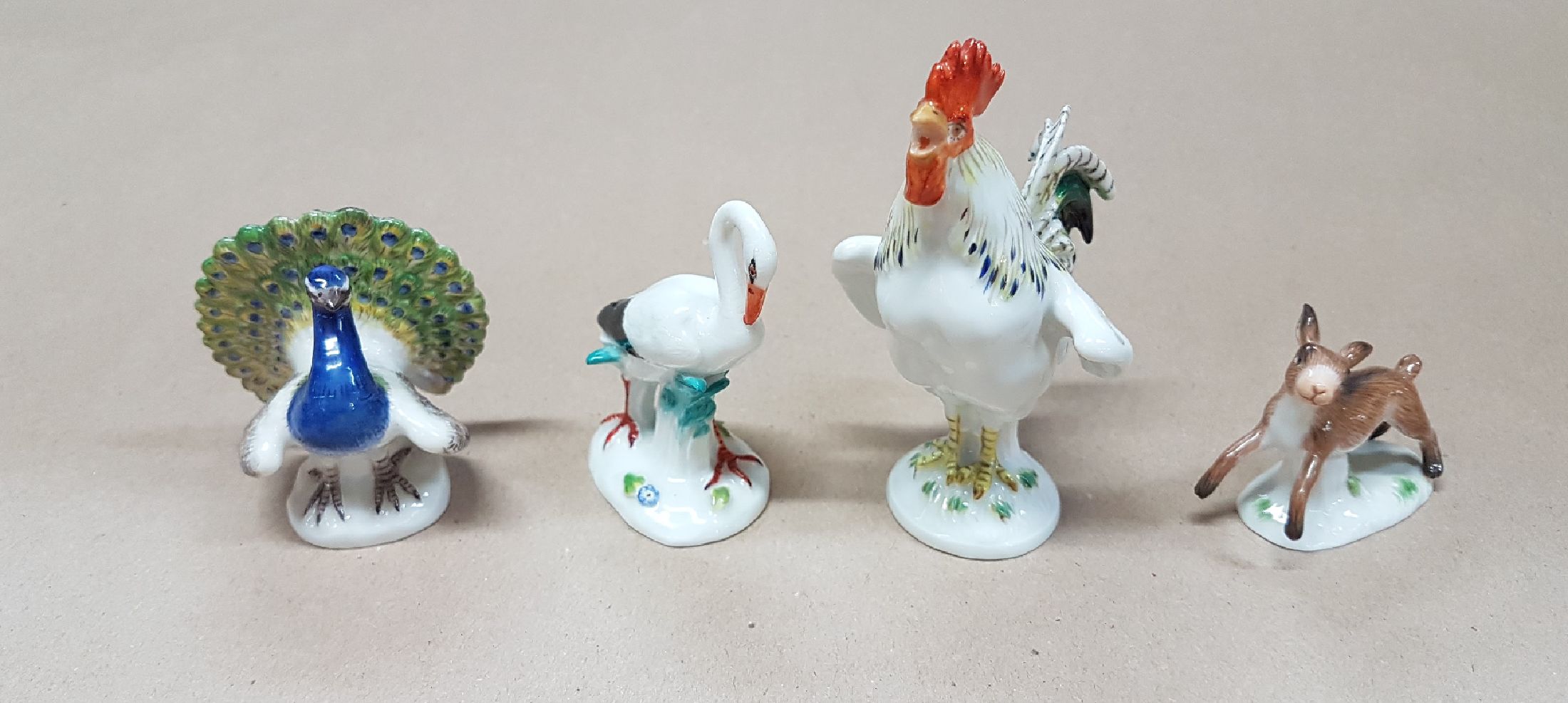 Detail a: Vier Miniaturen/Figuren, Meissen, 20. Jh., Tierfiguren, polychrom bemalt, Hahn H. 9cm, 4x5cm. Pfau H. 5.3 cm; Storch ca. 6.2 cm