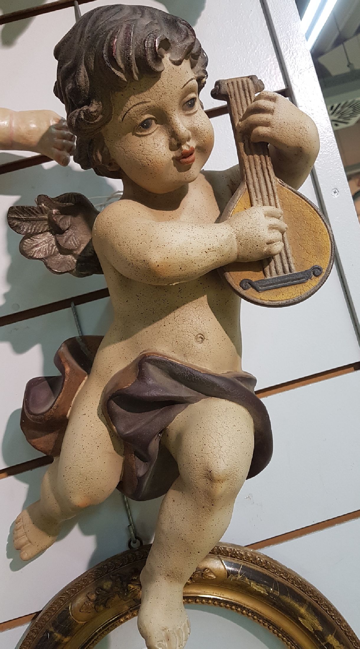Detail a: Paar Putten, 20.Jh., Kunstguss, polychrom bemalt, Darstellung je mit Flöte und Mandoline, Alterssp., H. je. 47 cm