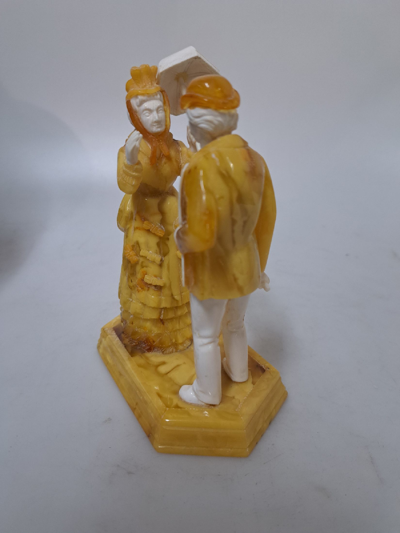 Detail c: Alfred Schlegge, 1923-2015, Figurengruppe, elegantes Paar aus Bernstein und Elfenbein, fein geschnitzt, auf sechseckigem Sockel stehende Paar, dame ...