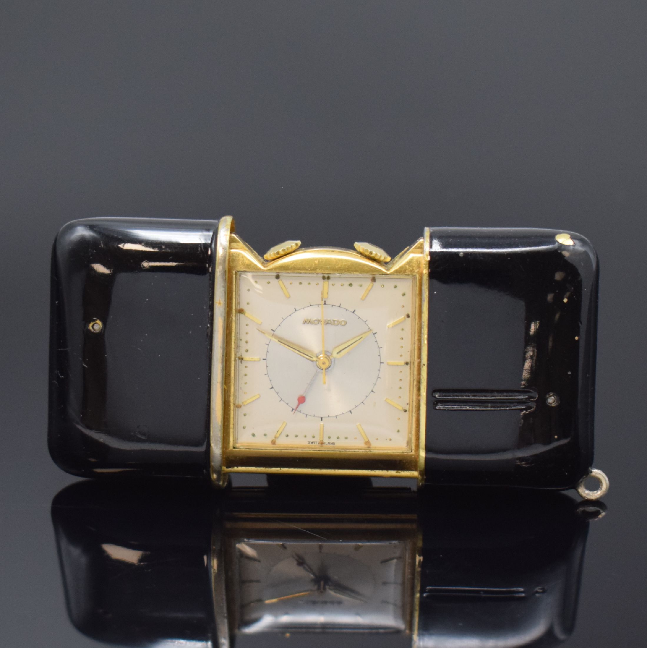 MOVADO Ermetophon vergoldeter Taschenwecker, Schweiz um 1950, Schiebeaufzug, verg. Geh. m. aufstellbarem Bügel, Kapsel später schwarz lackiert, ...