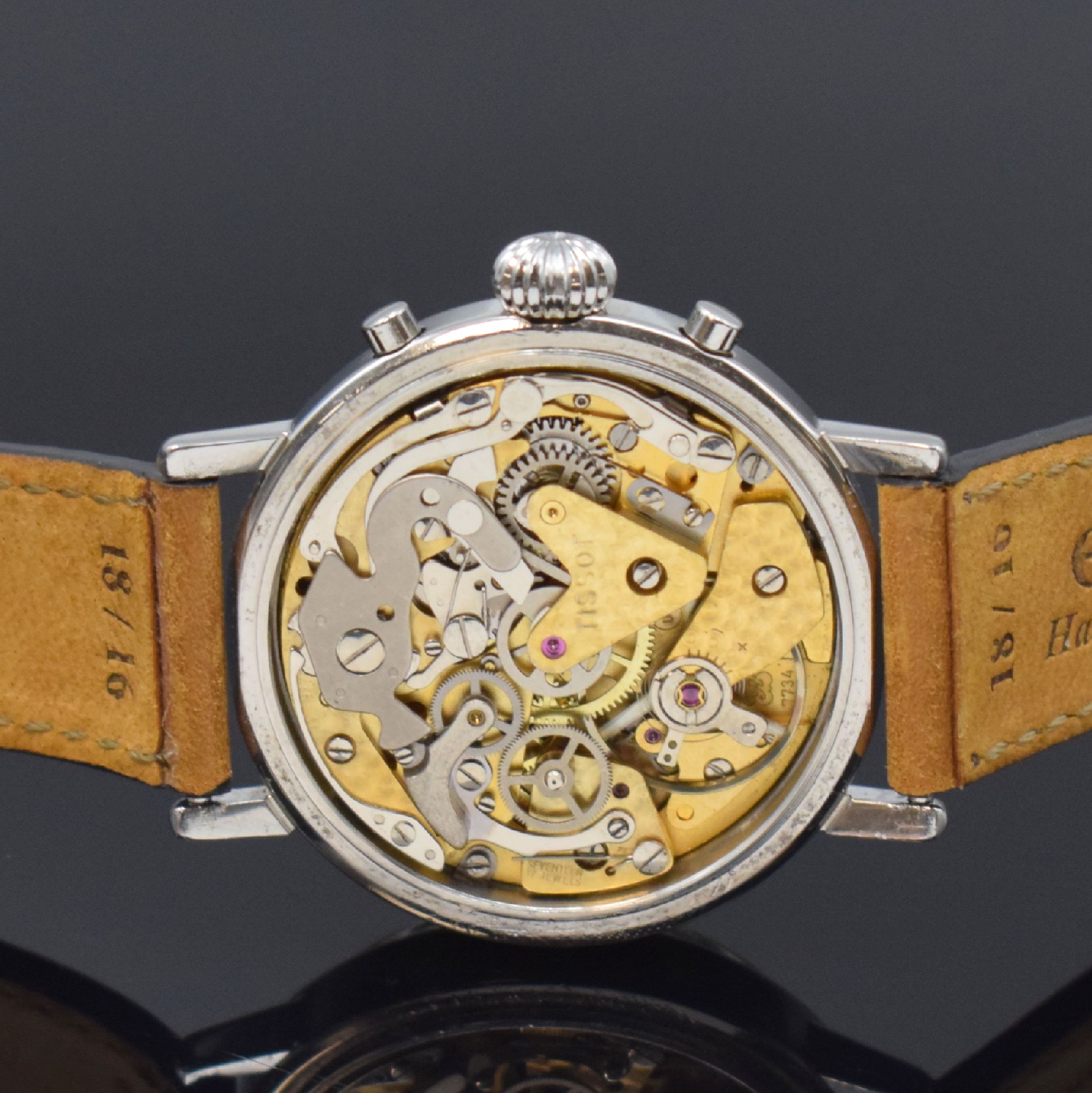 Detail e: TISSOT Herrenarmbanduhr mit Chronograph und Mondphase, Schweiz um 1985, Handaufzug, Stahlgeh., Boden gedr., verg. Lünette, silb. Zifferbl. m. ...