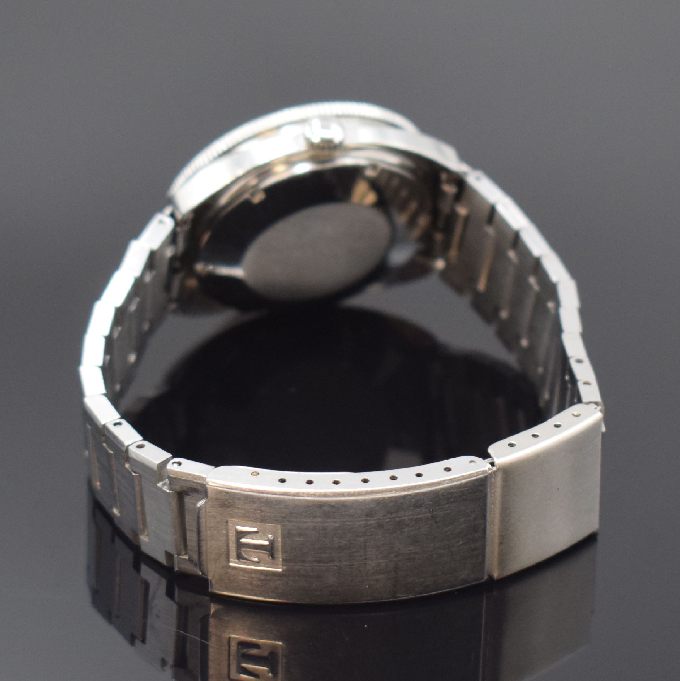 Detail b: TISSOT Navigator Herrenarmbanduhr, Schweiz um 1975, Automatik, Edelstahlgeh., Boden geschr., orig. Gliederband m. Faltschl., eins. drehb. Lünette, ...