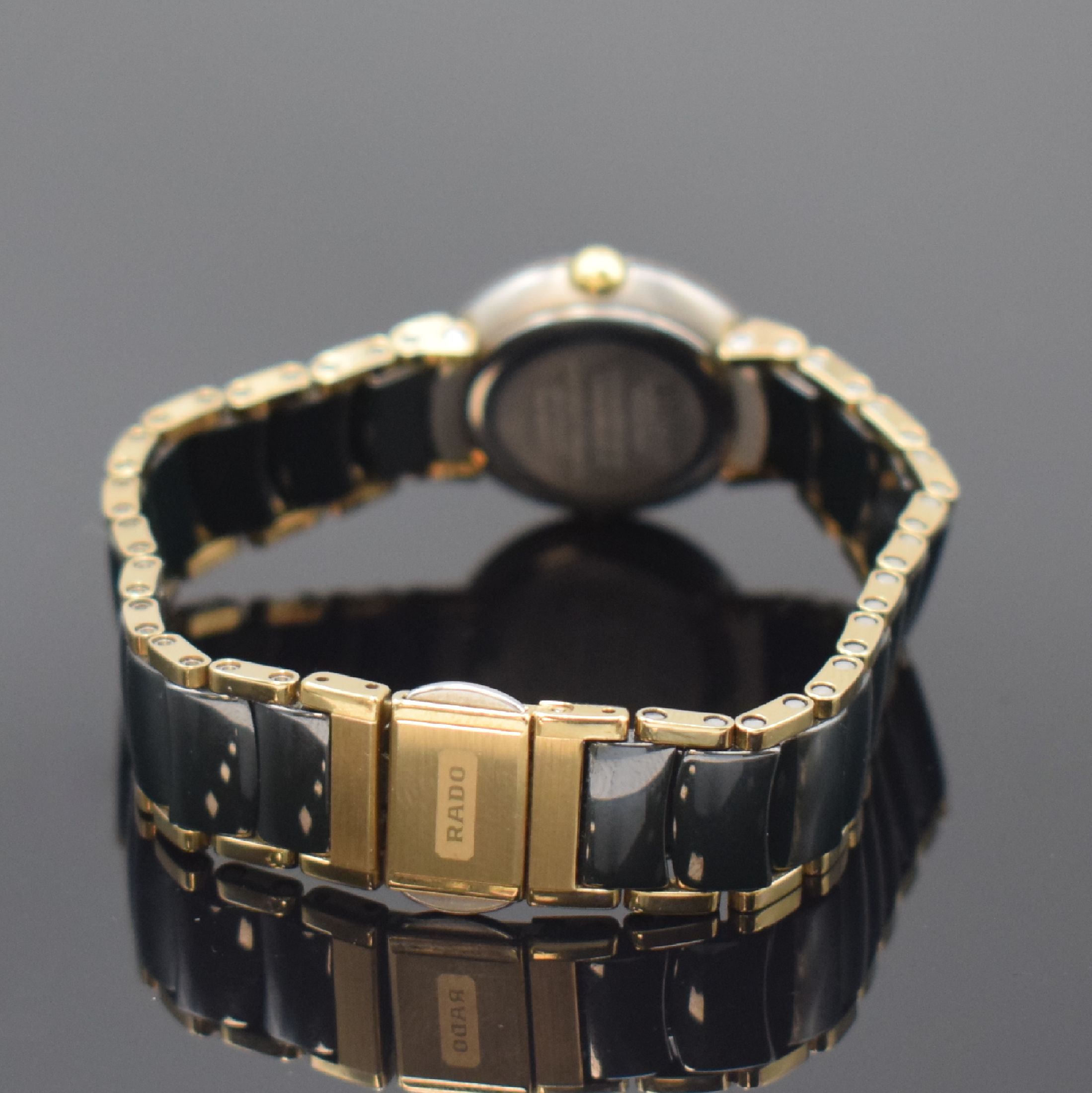 Detail b: RADO Jubile Damenarmbanduhr Referenz 204.0302.3, Schweiz um 2000, quarz, 2-teil. Edelstahlgeh., Boden aufgedr., schwarzes Zifferbl., gold. Zeiger, ...