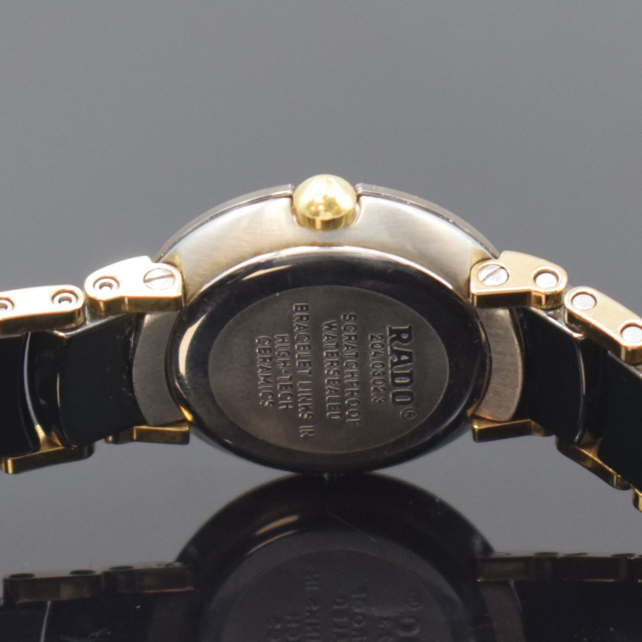 Detail d: RADO Jubile Damenarmbanduhr Referenz 204.0302.3, Schweiz um 2000, quarz, 2-teil. Edelstahlgeh., Boden aufgedr., schwarzes Zifferbl., gold. Zeiger, ...