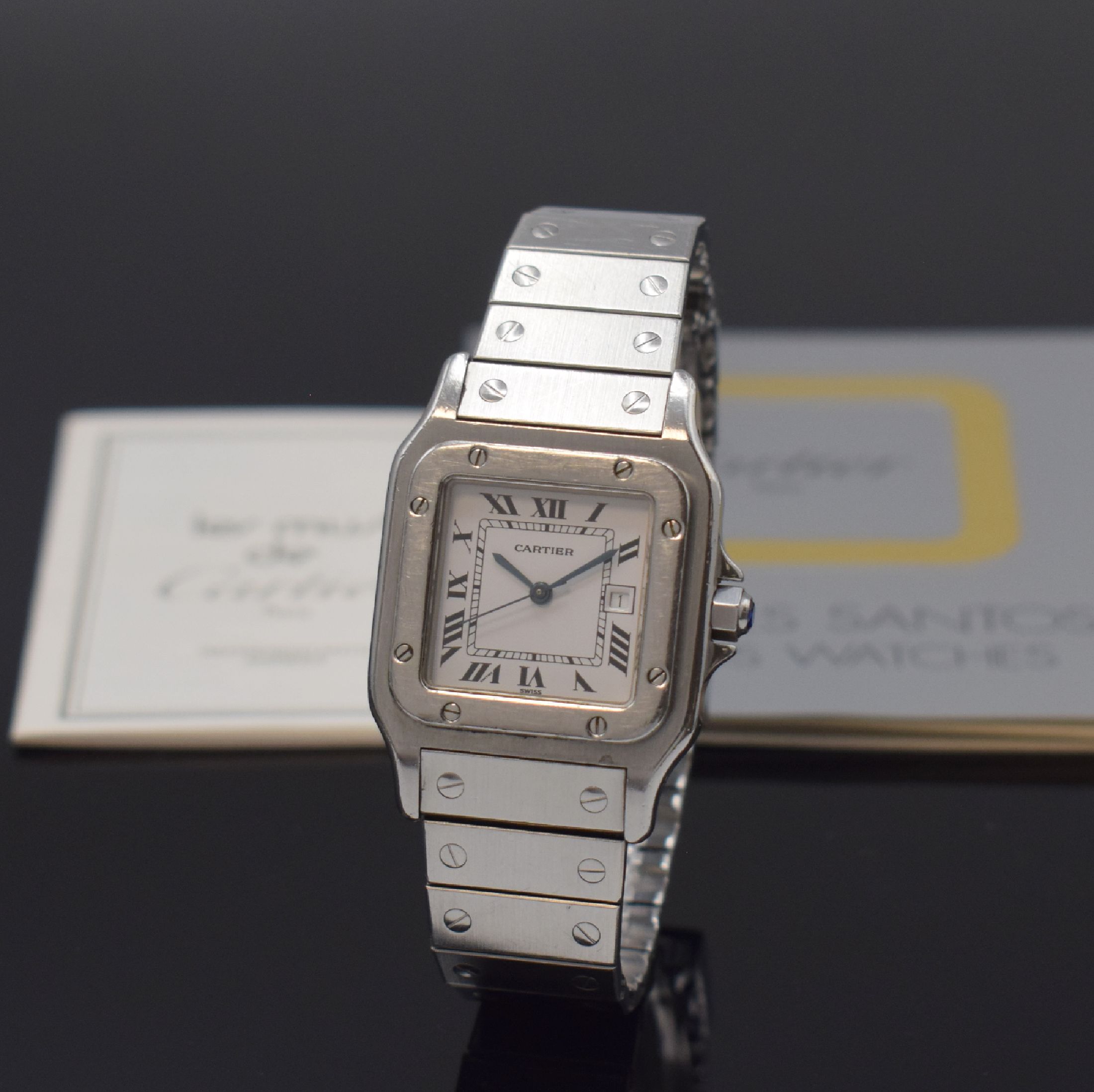 CARTIER Santos Armbanduhr in Stahl, Schweiz um 1985, Automatik, 8-fach über Lünette verschr. Geh., Krone m. Schmuckstein bes., orig. Stahlband m. ...