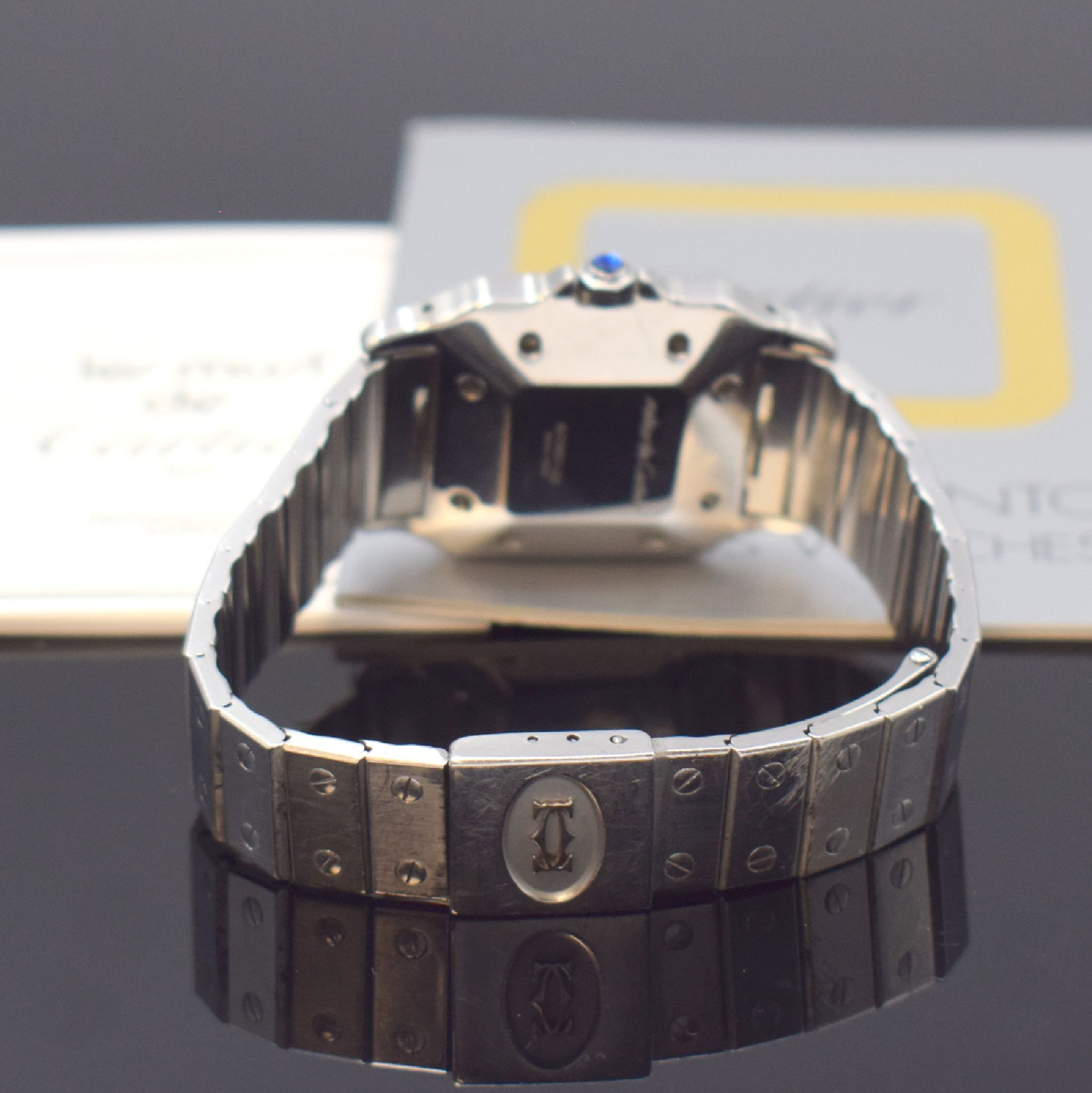 Detail b: CARTIER Santos Armbanduhr in Stahl, Schweiz um 1985, Automatik, 8-fach über Lünette verschr. Geh., Krone m. Schmuckstein bes., orig. Stahlband m. ...