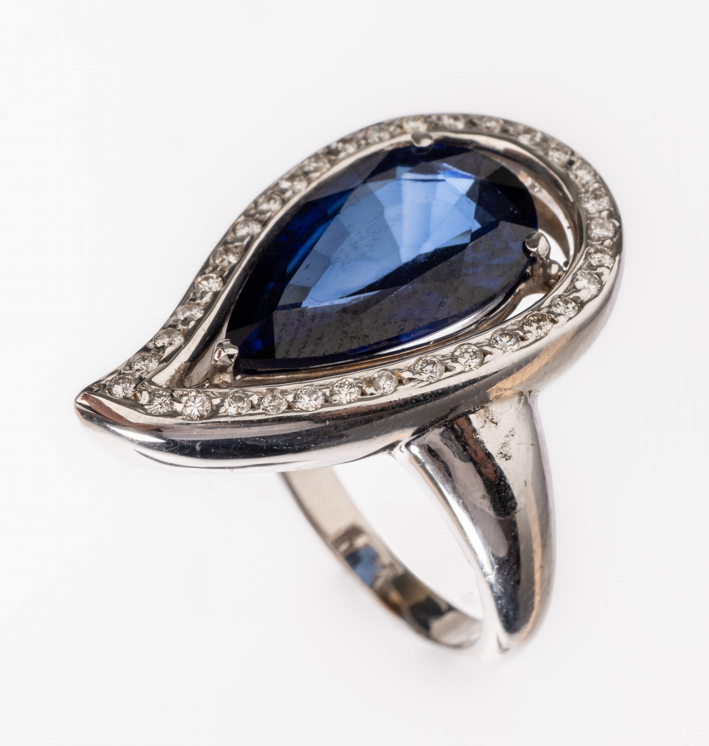 18 kt Gold Brillant-Saphir-Ring, WG 750/000, tropfenförm., wohl synth. Saphir ca. 7.00 ct, 34 Brillanten zus. ca. 0.34 ct Weiß- l.get.Weiß/si-p, ...