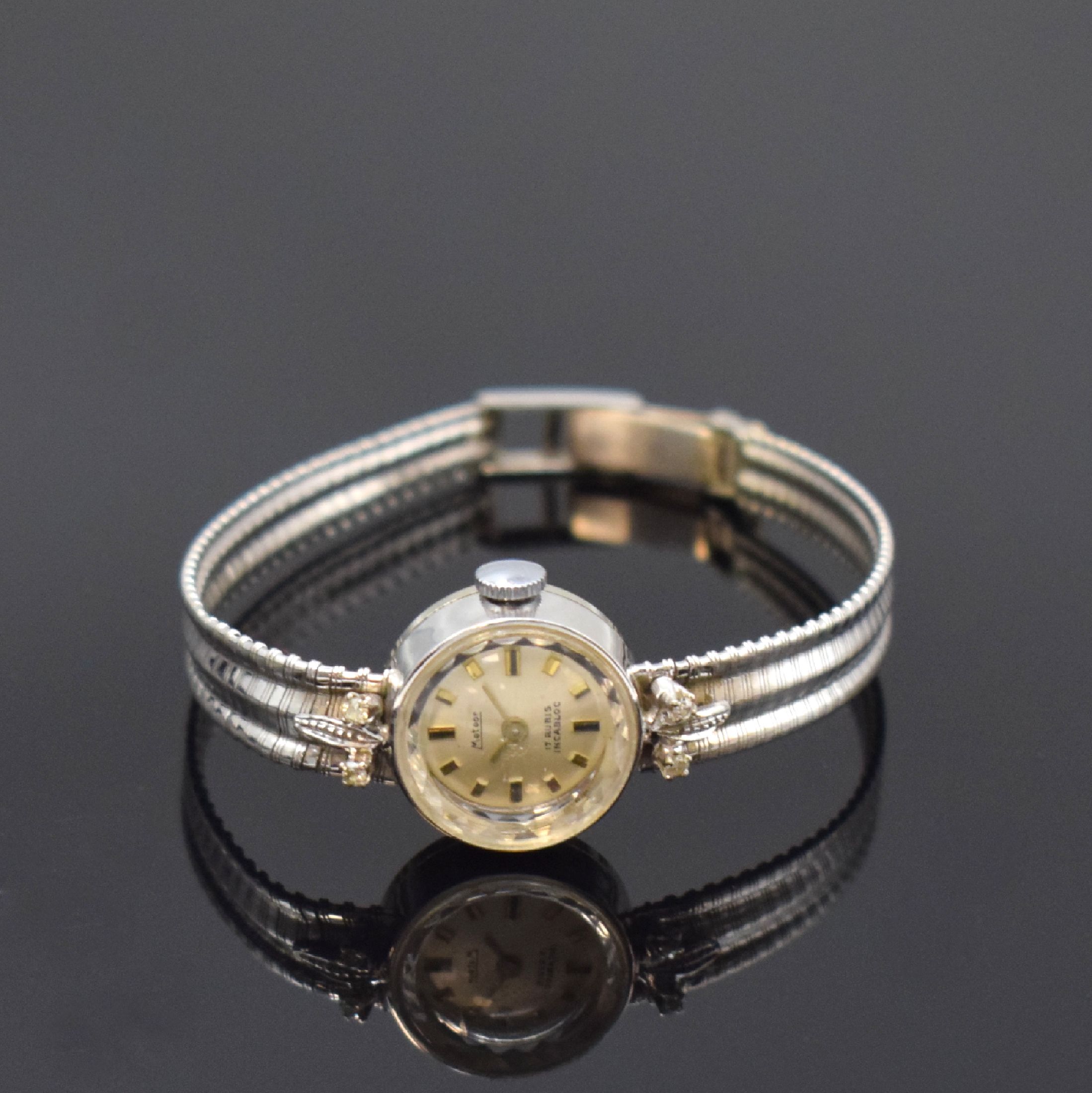 METEOR Diamantbesetzte Damenarmbanduhr in WG 750/000, Schweiz um 1960, Handaufzug, 2- teil. Geh. m. aufgedr. Boden, anges. Band, silb. Zifferbl., ...