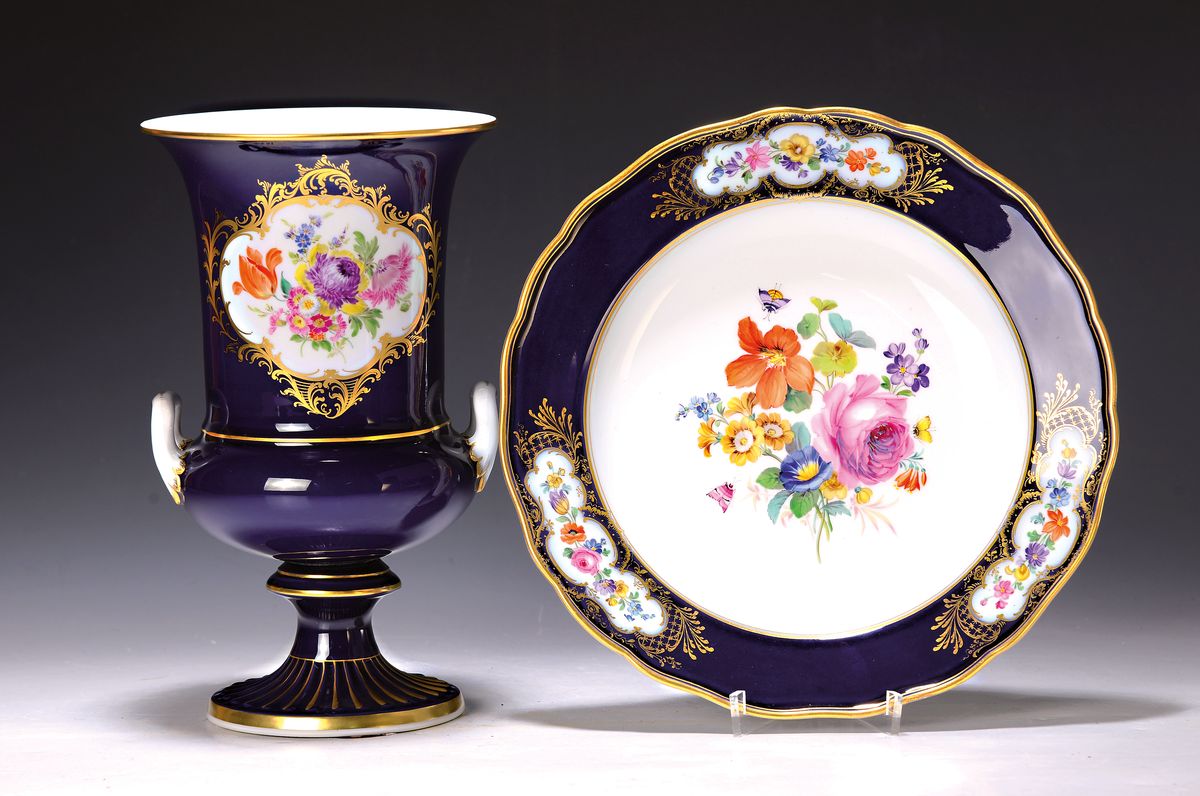 Teller und Doppelhenkelvase, Meissen, 20.Jh., Porzellan, Teller, 1.Wahl, königsblau glasiert, Blumenmalerei in der Mitte und in den Schildern, ...
