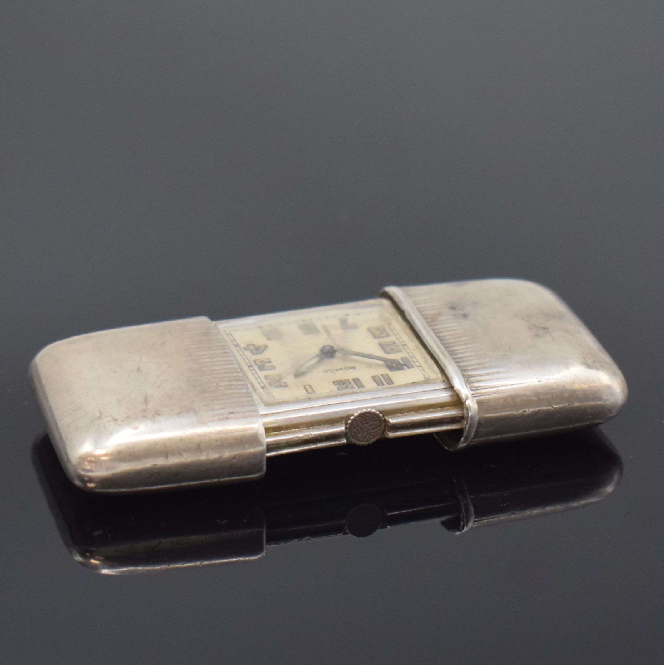 Detail c: MOVADO Ermeto Reiseuhr in 935er Silber, Schweiz um 1935, Geh. dell., Aufzug durch aufschieben u. schließen, silb. Zifferbl. pat./fl., arab. ...