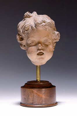 Image 26706241 - Putti head, ceramic, around 1880/1900, fragment, placed on a wooden stand, height approx. 24 cm