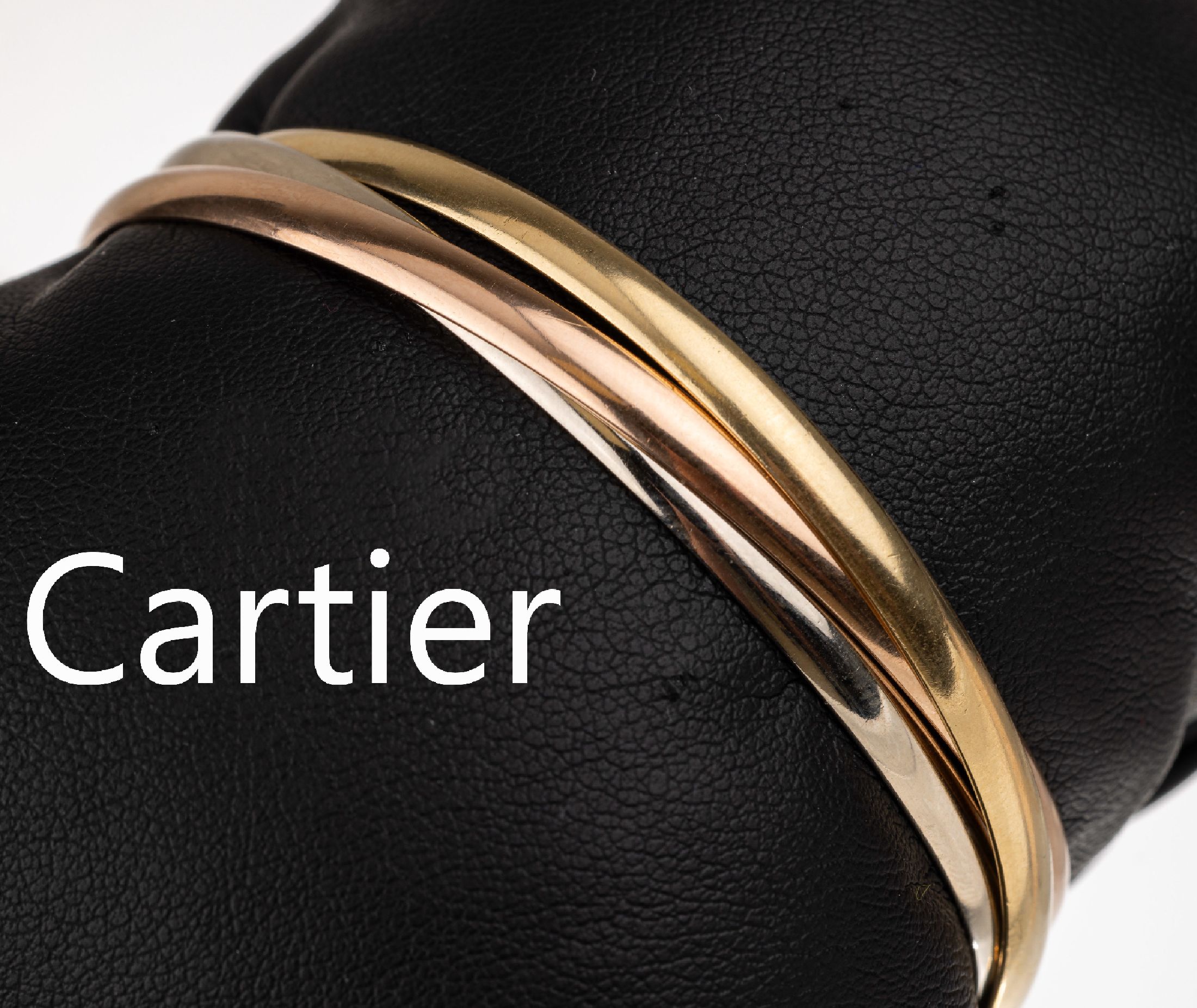 18 kt Gold CARTIER Armreif, GG/RG/WG 750/000, aus der Trinity-Serie, D. ca. 6.0 cm,ca. 29.3 g, sign., num., mit orig. Zertifikat