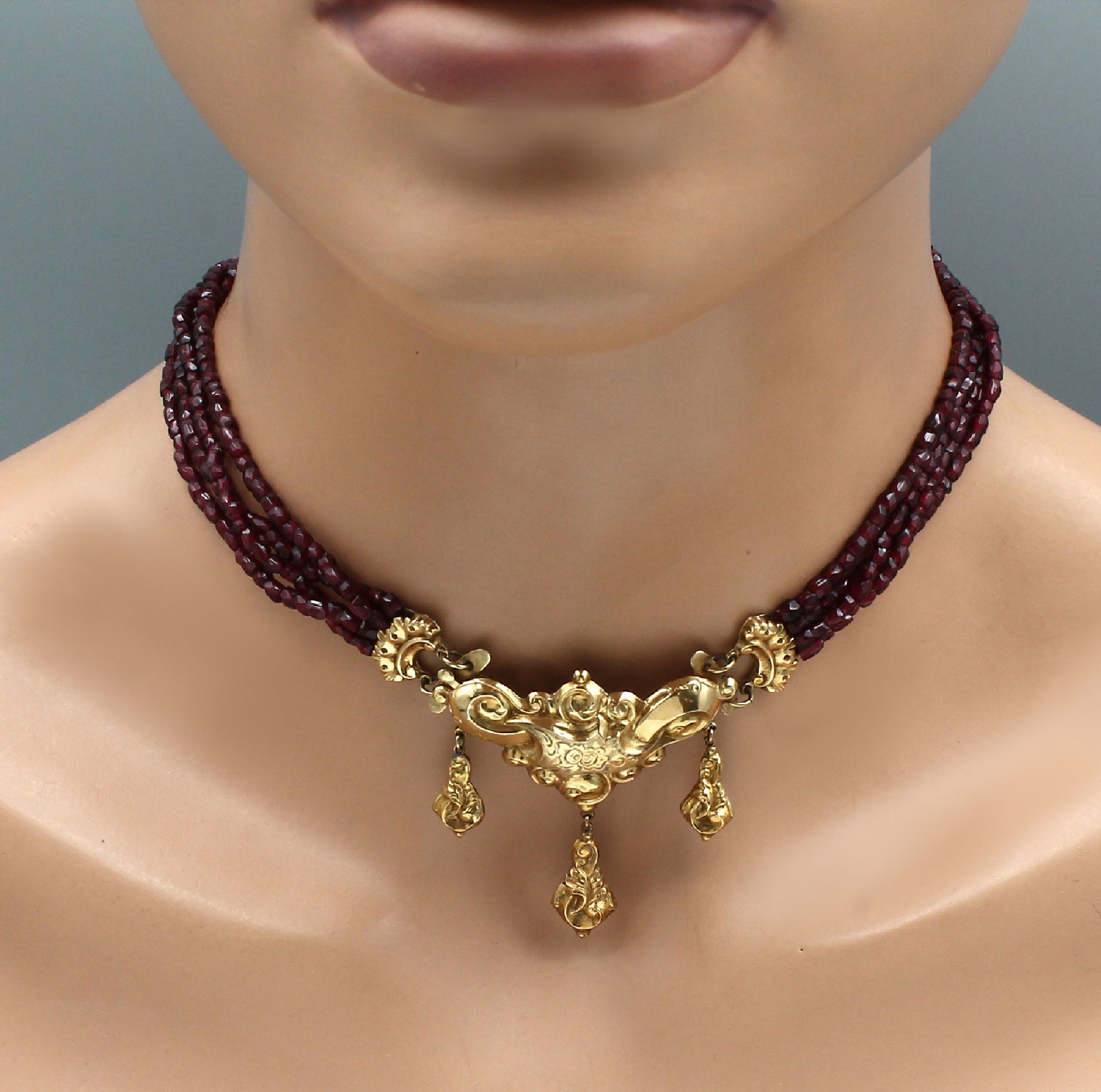 Detail a: 4-reihiges Granatcollier, Böhmen um 1840/50, Collier Mittelteil GG 585/000, grav. und pol., 3 bewegliche Abhängungen, facett. Granate, L. ca. 37 cm