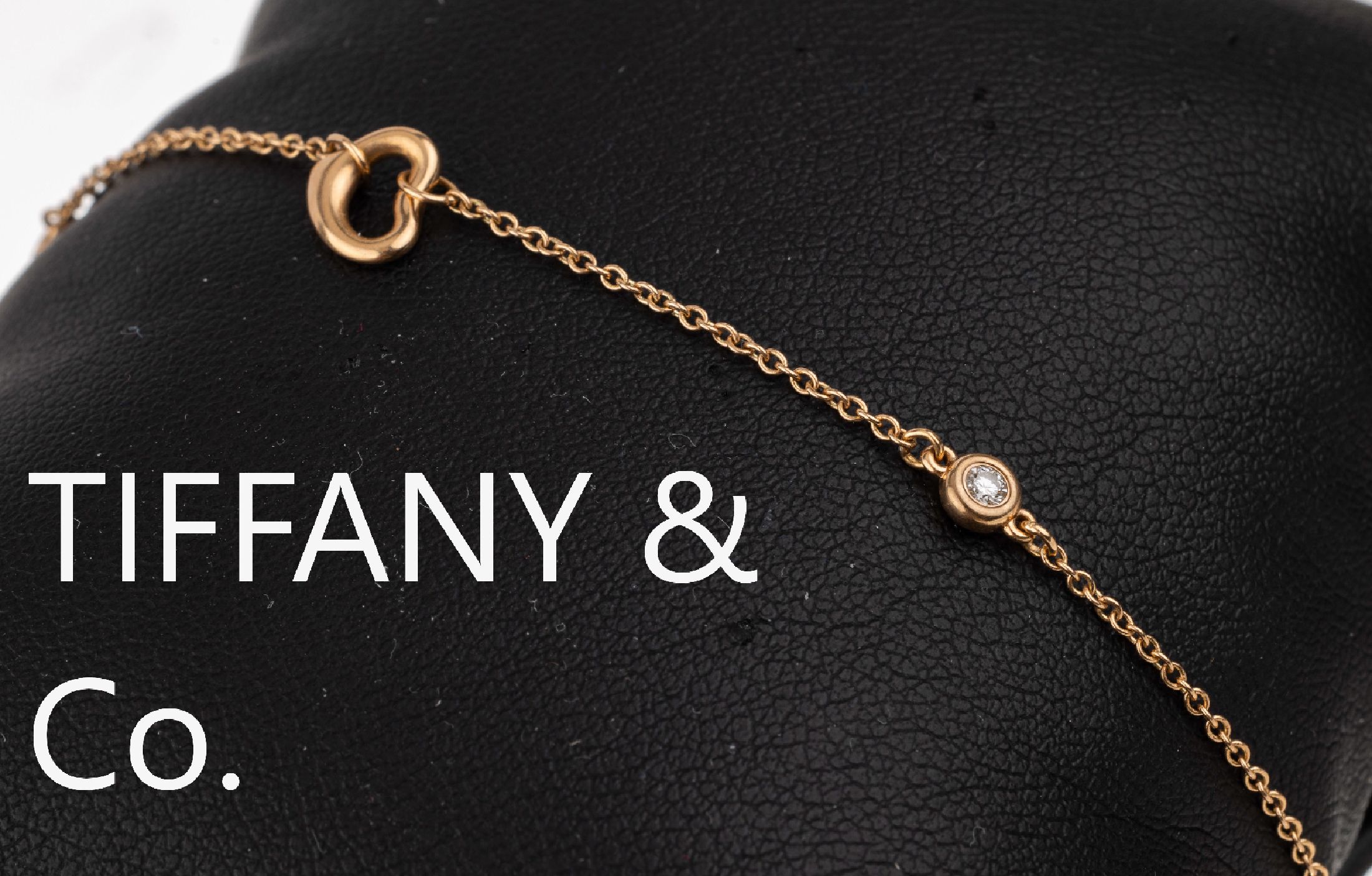 18 kt Gold TIFFANY & Co. Armband, RG 750/000, sign. Tiffany & Co. Spain, 2 Brillanten zus. ca. 0.06 ct feines Weiß-Weiß/lr-vs, L. ca. 17 cm, ...