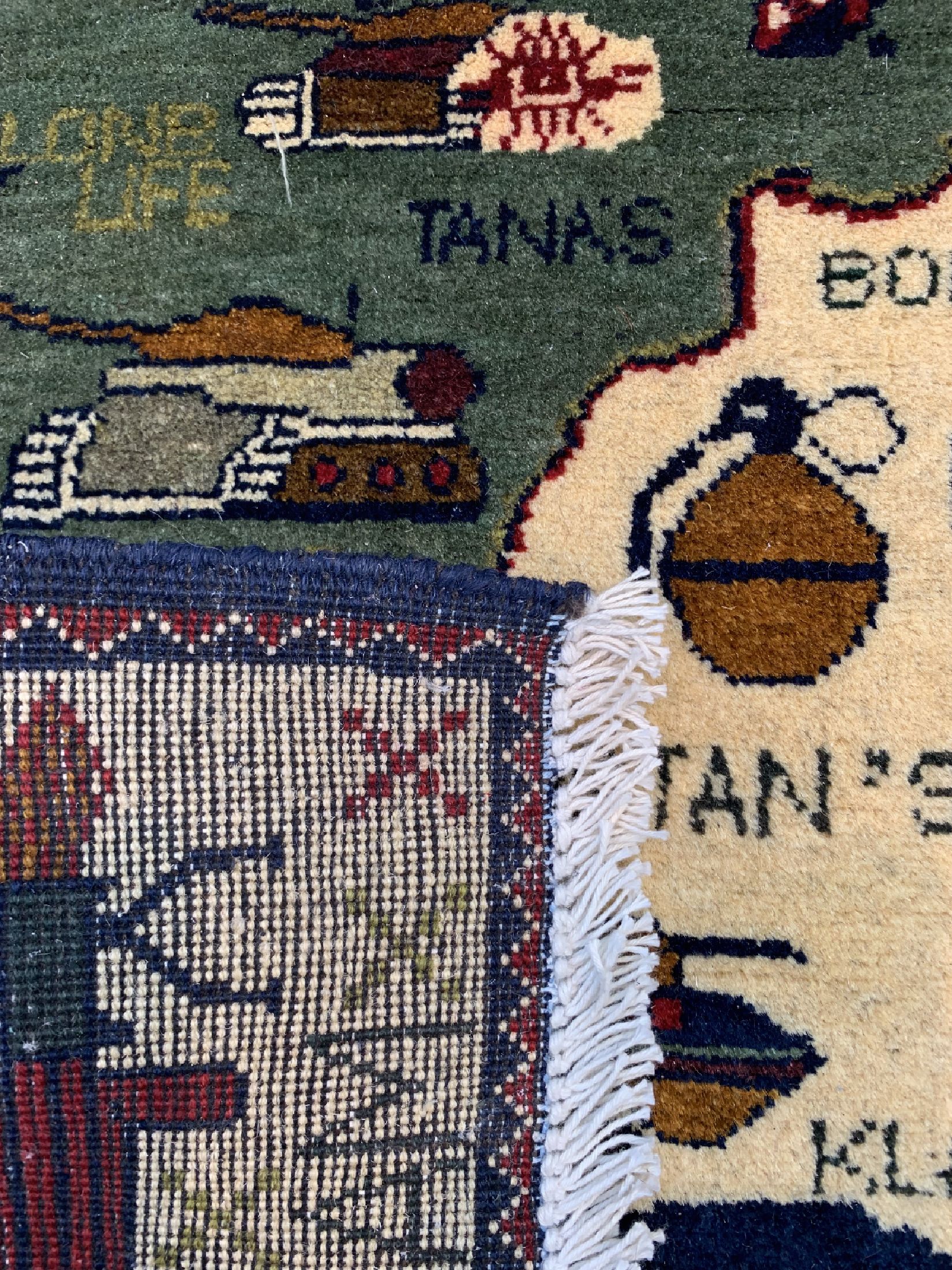 Detail b: Paar "Kriegsteppiche", Afghanistan, ca. 50 Jahre, Wolle auf Wolle, ca. 250 x 128 cm, verfärbt, ca. 73 x 63 cm, Mottenfraß.