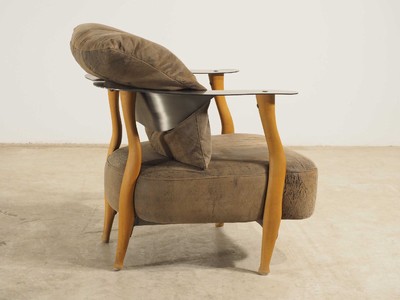 26713873c - Design armchair by Kurt Beier, model: Fantasy Island, beech wood frame with steel backrest, brown leather covers with some black marbling, including 4 loose pillows, signs of age and use, approx. 67x80x77 cm