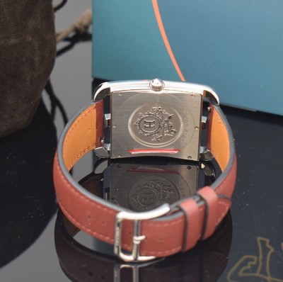 26714933d - HERMES wristwatch series Cape Cod reference CC1.810, stainless steel case including original leather strap with original buckle, quartz, case back 6-times screwed, red dial with Arabic hours, display of hours, minutes, sweep seconds & date, measures approx. 33 x 46 mm, Hermes storage back enclosed, unworn stock, condition 1-2