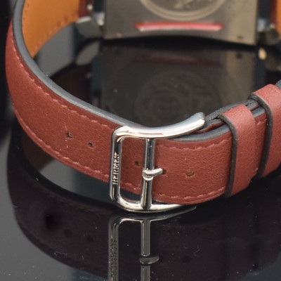 26714933e - HERMES wristwatch series Cape Cod reference CC1.810, stainless steel case including original leather strap with original buckle, quartz, case back 6-times screwed, red dial with Arabic hours, display of hours, minutes, sweep seconds & date, measures approx. 33 x 46 mm, Hermes storage back enclosed, unworn stock, condition 1-2