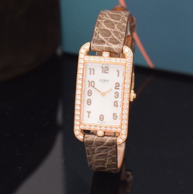 Image HERMES ladies wristwatch series Nantucket reference NA2.271, 18k pink gold including original leather strap with original 18k pink gold buckle, quartz, case back screwed-down 4 -times, case at the sides lavish diamonds set, mother of pearl dial, display of hours & minutes, measures approx. 37 x 20 mm, Hermes storage back enclosed, unworn stock, condition 1-2