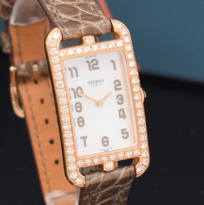 26714969c - HERMES ladies wristwatch series Nantucket reference NA2.271, 18k pink gold including original leather strap with original 18k pink gold buckle, quartz, case back screwed-down 4 -times, case at the sides lavish diamonds set, mother of pearl dial, display of hours & minutes, measures approx. 37 x 20 mm, Hermes storage back enclosed, unworn stock, condition 1-2
