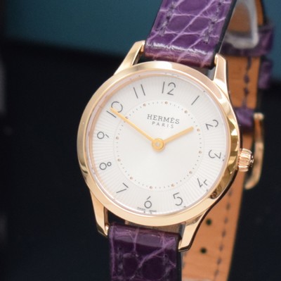 26714987a - HERMES wristwatch series Slim d´Hermes in 18k pink gold reference CA2.170, original leather strap with original 18k pink gold buckle, quartz, snap on case back, silvered, at the edge engine-turned dial with Arabic hours, display of hours & minutes, diameter approx. 25 mm, Hermes storage back enclosed, unworn stock, condition 1-2