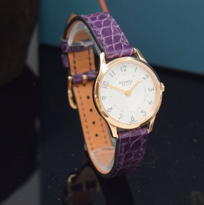 26714987b - HERMES wristwatch series Slim d´Hermes in 18k pink gold reference CA2.170, original leather strap with original 18k pink gold buckle, quartz, snap on case back, silvered, at the edge engine-turned dial with Arabic hours, display of hours & minutes, diameter approx. 25 mm, Hermes storage back enclosed, unworn stock, condition 1-2