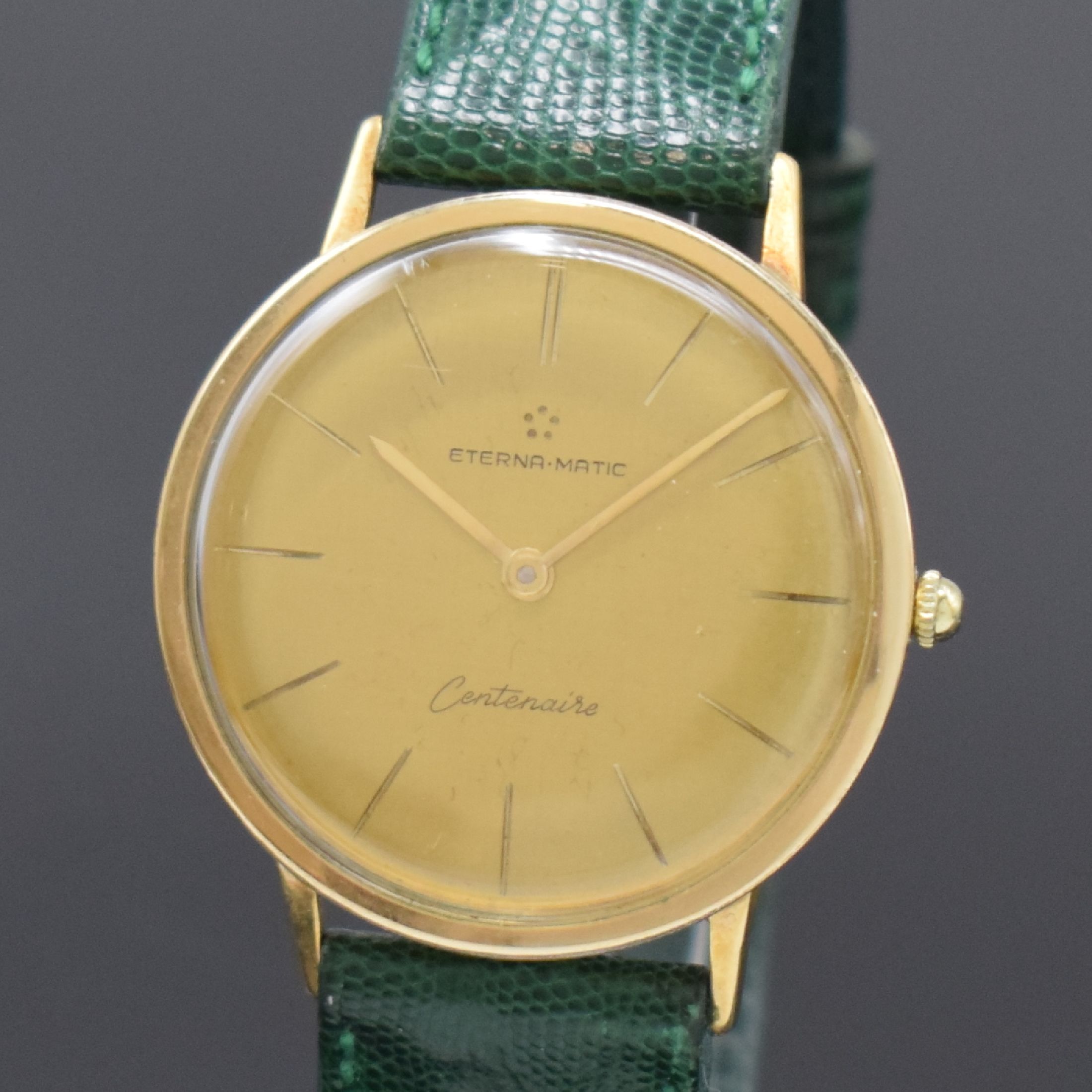 Detail a: ETERNA-MATIC Centenaire vergoldete Herrenarmbanduhr, Schweiz um 1960, Automatik, Boden u. Glasrand aufgedr., goldfarb. Zifferbl. m. aufges. ...