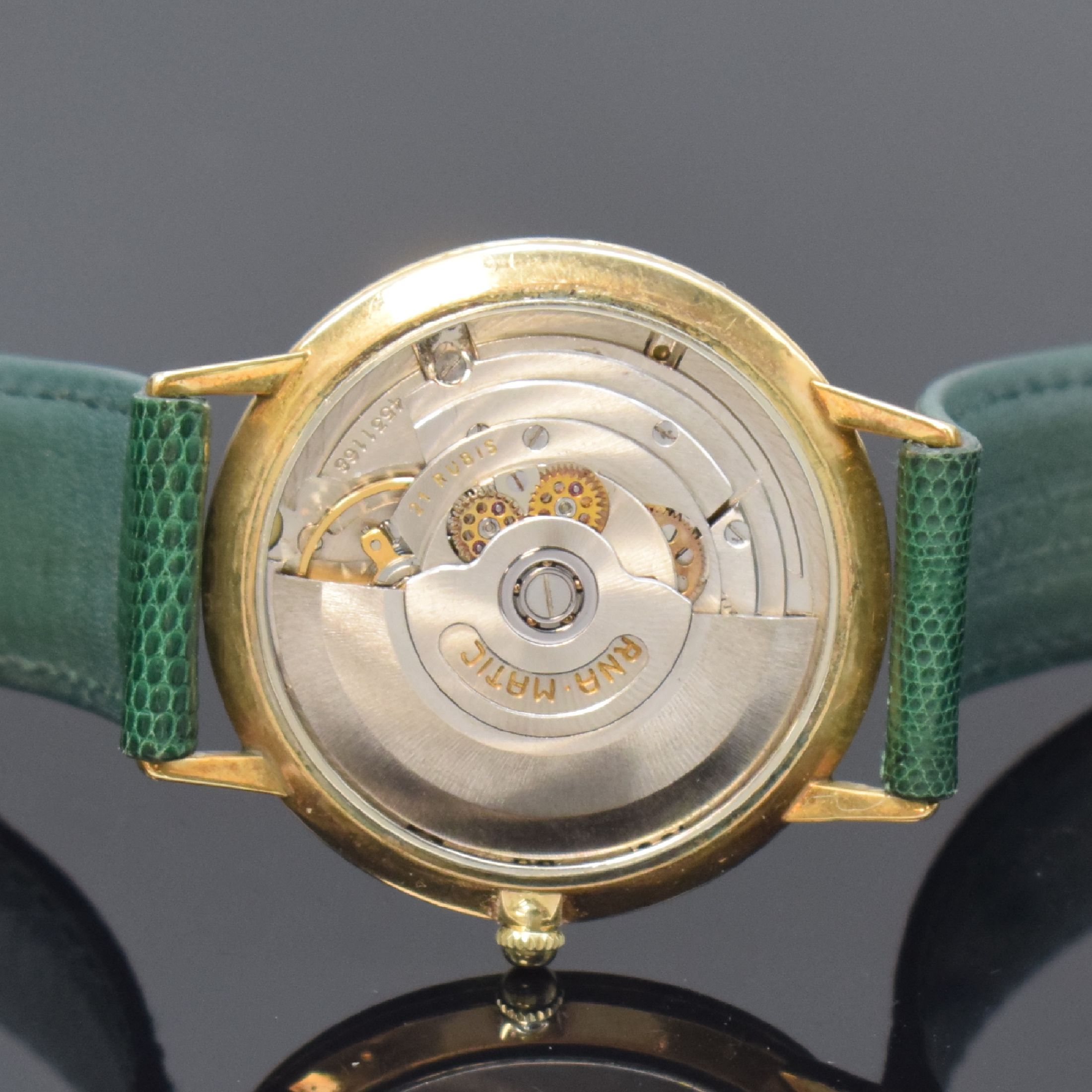 Detail e: ETERNA-MATIC Centenaire vergoldete Herrenarmbanduhr, Schweiz um 1960, Automatik, Boden u. Glasrand aufgedr., goldfarb. Zifferbl. m. aufges. ...
