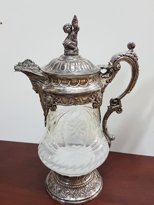 26721483a - Ceremonial jug, Topazio Portugal, with 925 silver fittings, cut and cut crystal glass body, heavy sterling silver fittings in the Renaissance style with bacchant, masquerade and leaves and volutes, height approx. 35cm