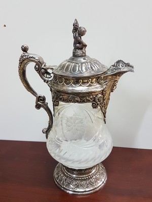 26721483b - Ceremonial jug, Topazio Portugal, with 925 silver fittings, cut and cut crystal glass body, heavy sterling silver fittings in the Renaissance style with bacchant, masquerade and leaves and volutes, height approx. 35cm