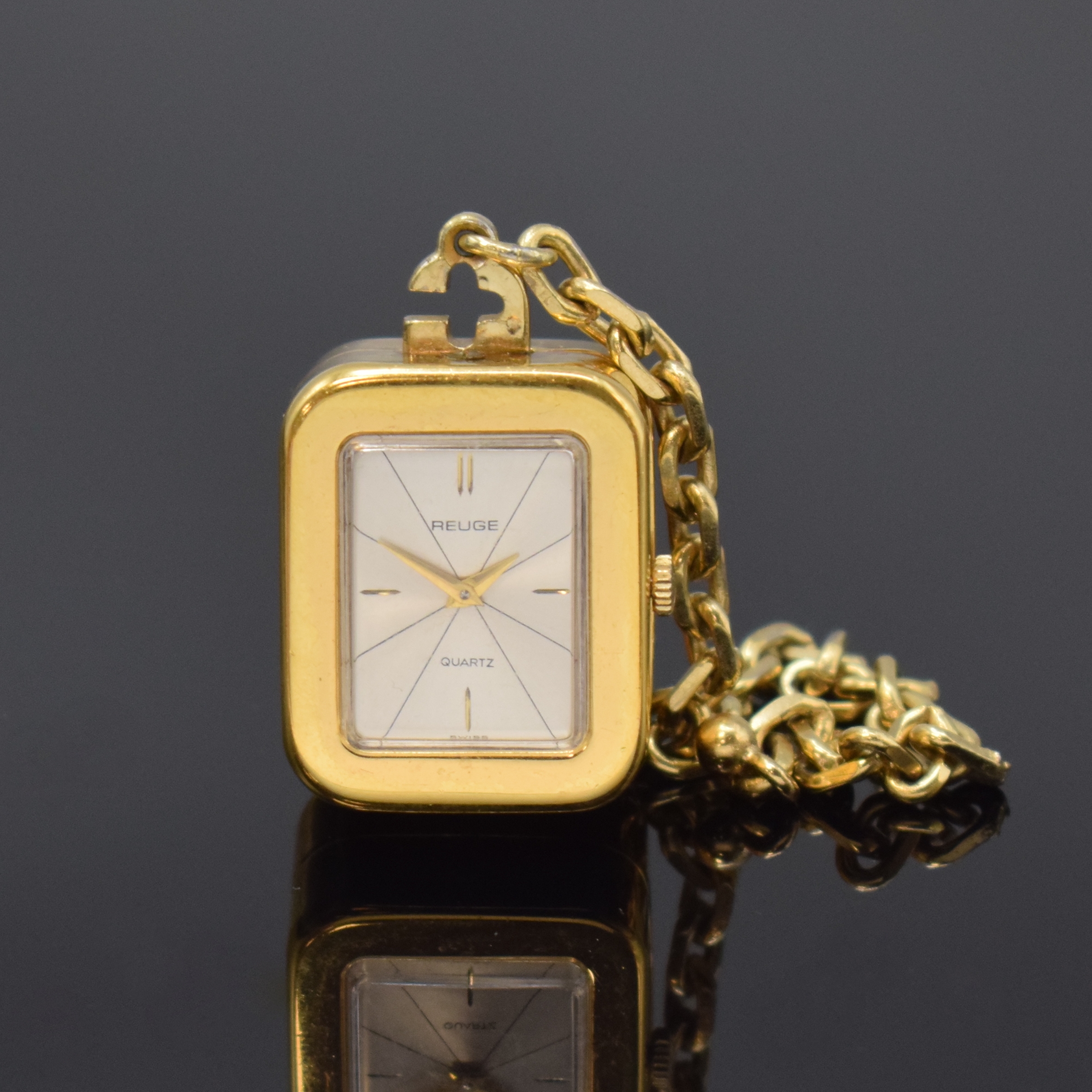 REUGE Miniatur-Uhr mit Spielwerk, Schweiz um 1980, Quarz-Uhrwerk, verg. Geh., silb. Zifferbl. m. gold. Zeiger, Anz. v. Std. u. Min., Walzenspielwerk, ...