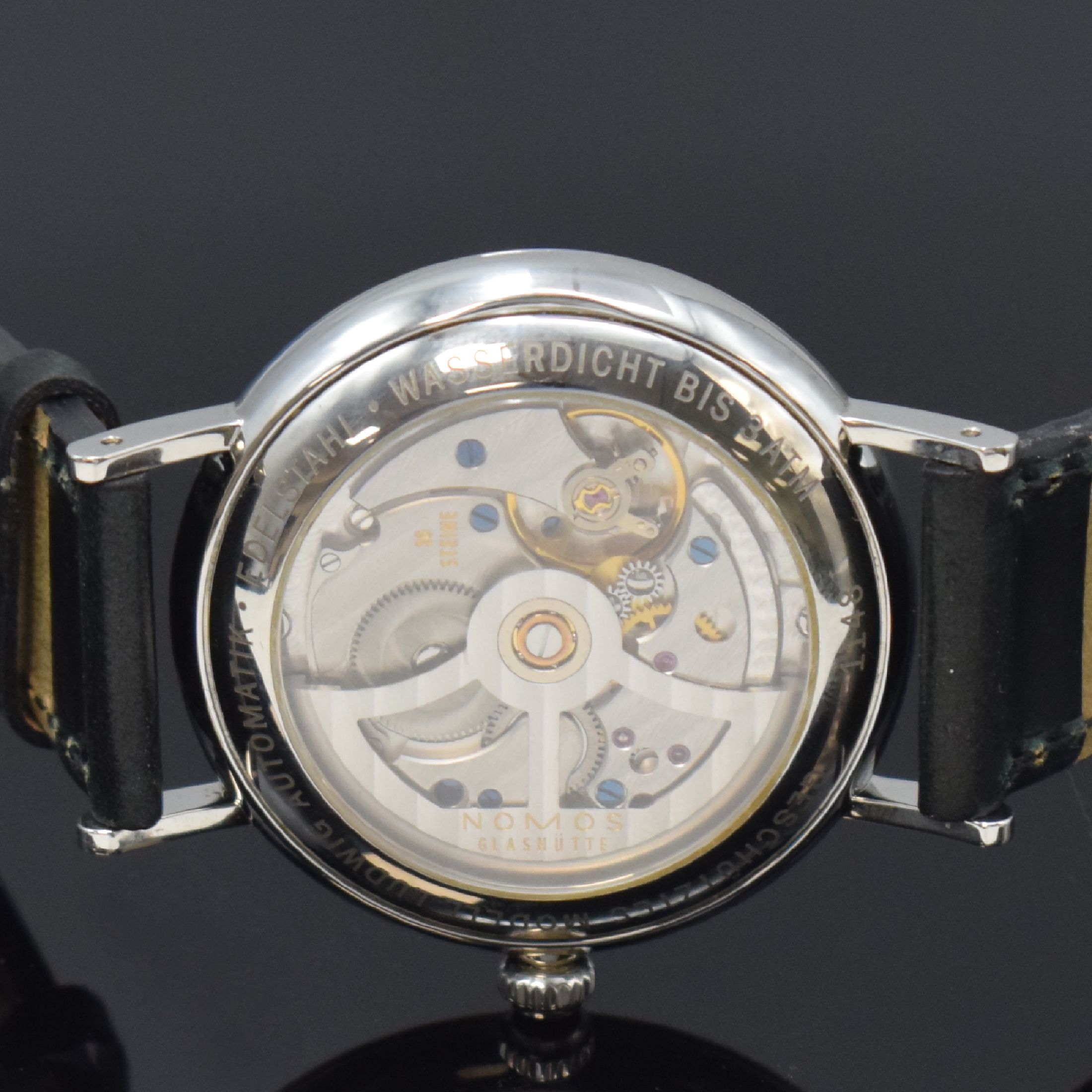 Detail e: NOMOS Glashütte Herrenarmbanduhr Modell Ludwig, Deutschland um 2010, Automatik, beids. vergl. Edelstahlgeh. m. orig. Lederband u. Dornschl., Boden ...