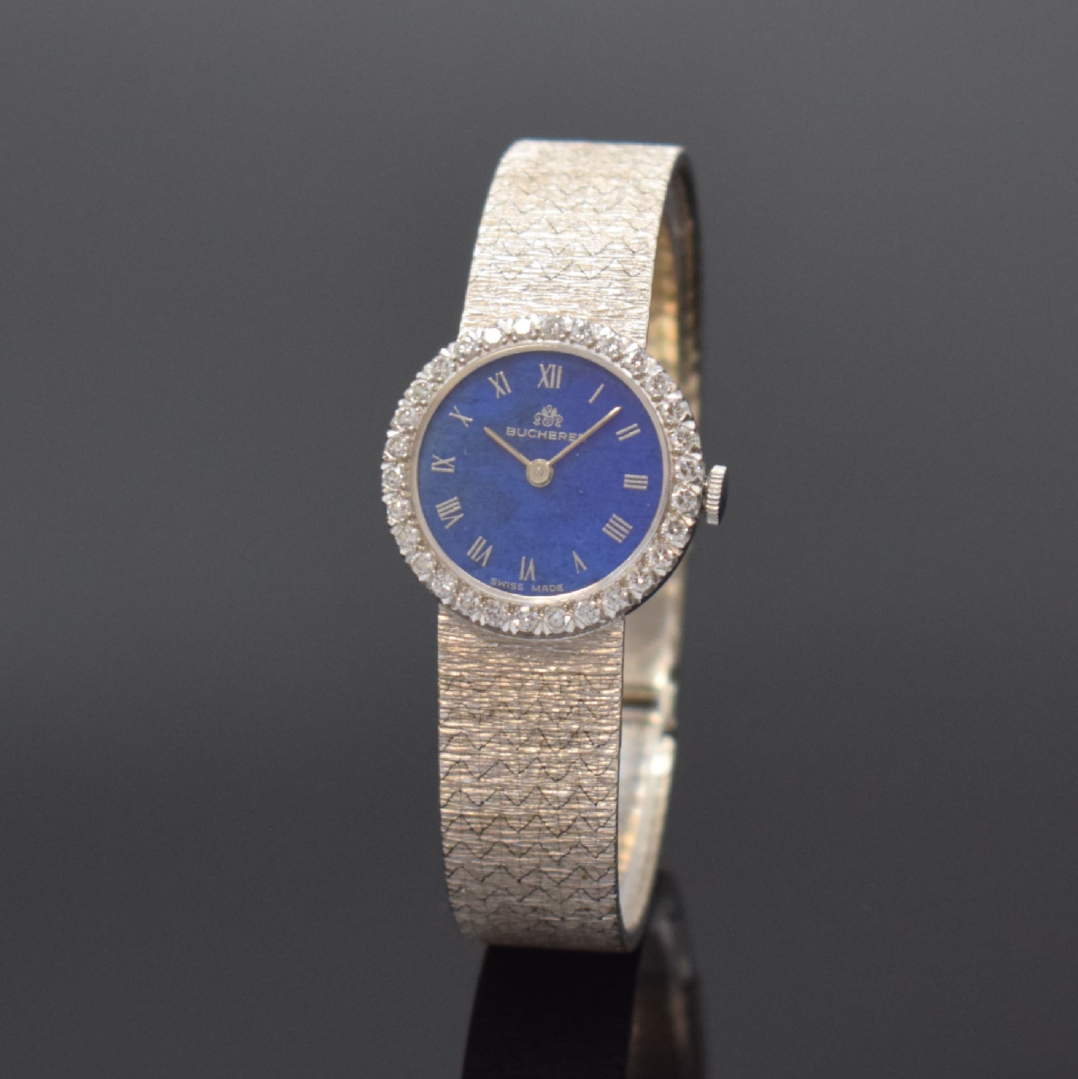 BUCHERER Damenschmuckuhr in WG 585/000 mit Diamanten, Schweiz um 1965, Boden aufgedr., Lünette aufw. m. Diamanten bes., Lapislazuli- Zifferblatt m. ...