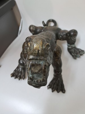 26723384c - Bronze sculpture of one of the Nine Dragons, China, late Qing/19th century, black patinated bronze, back and limbs with seal script in gold based on the model of the Han and Qing, probably depicting Chaofeng or Bian as sons of the Nine Dragons, rare form, rubbed, oxidized in spots, 28x48x36 cm; Provenance: from a German private collection, acquired from the Chinese art trade in 1998
